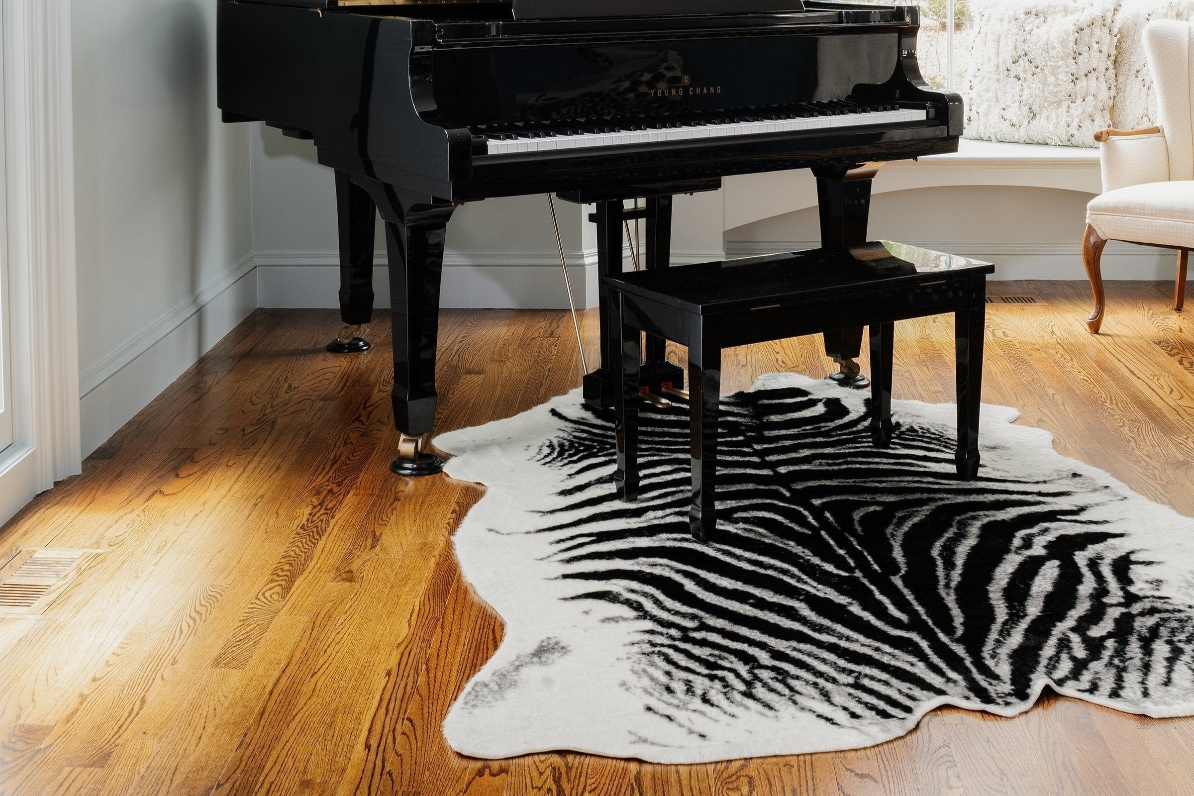 Erin Gates Acadia area rug featuring bold zebra and cheetah animal print patterns, cruelty-free acrylic and polyester blend, suede backing, luxury texture, cosmopolitan style