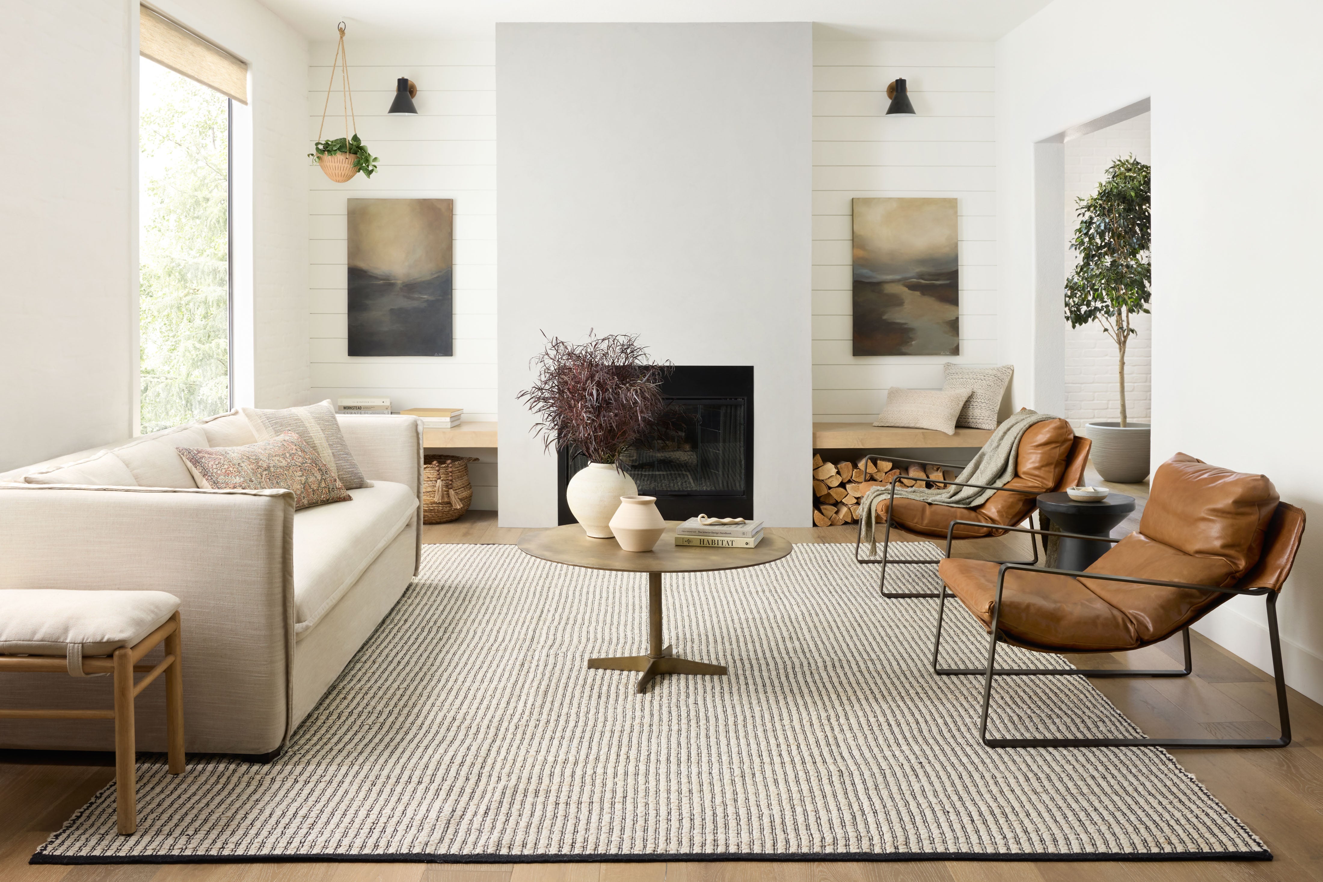 Hand-woven jute and cotton rug from the Colton Collection by Angela Rose x Loloi, featuring linear patterns in earthy tones, displayed in a modern home setting.