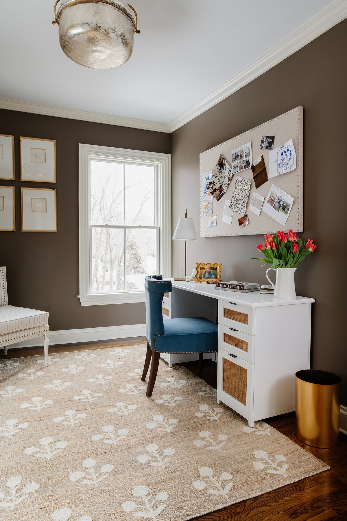 Erin Gates by Momeni Beige and white patterned Orchard rug in a home office with a blue velvet chair, white desk, and large cork bulletin board.