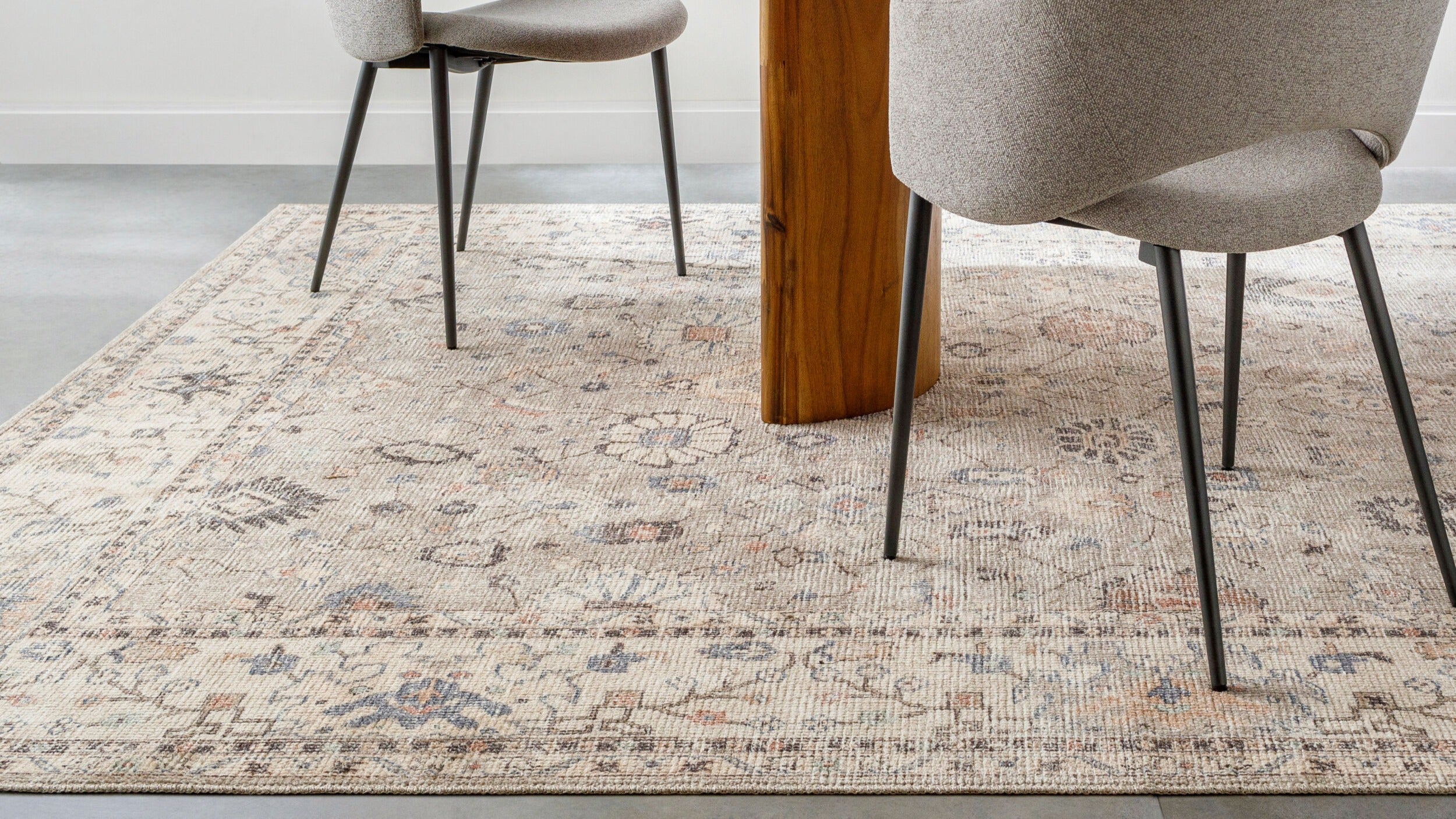 Becki Owens x Livabliss Davina rug with traditional patterns under dining chairs, machine-woven in Turkey for timeless elegance.
