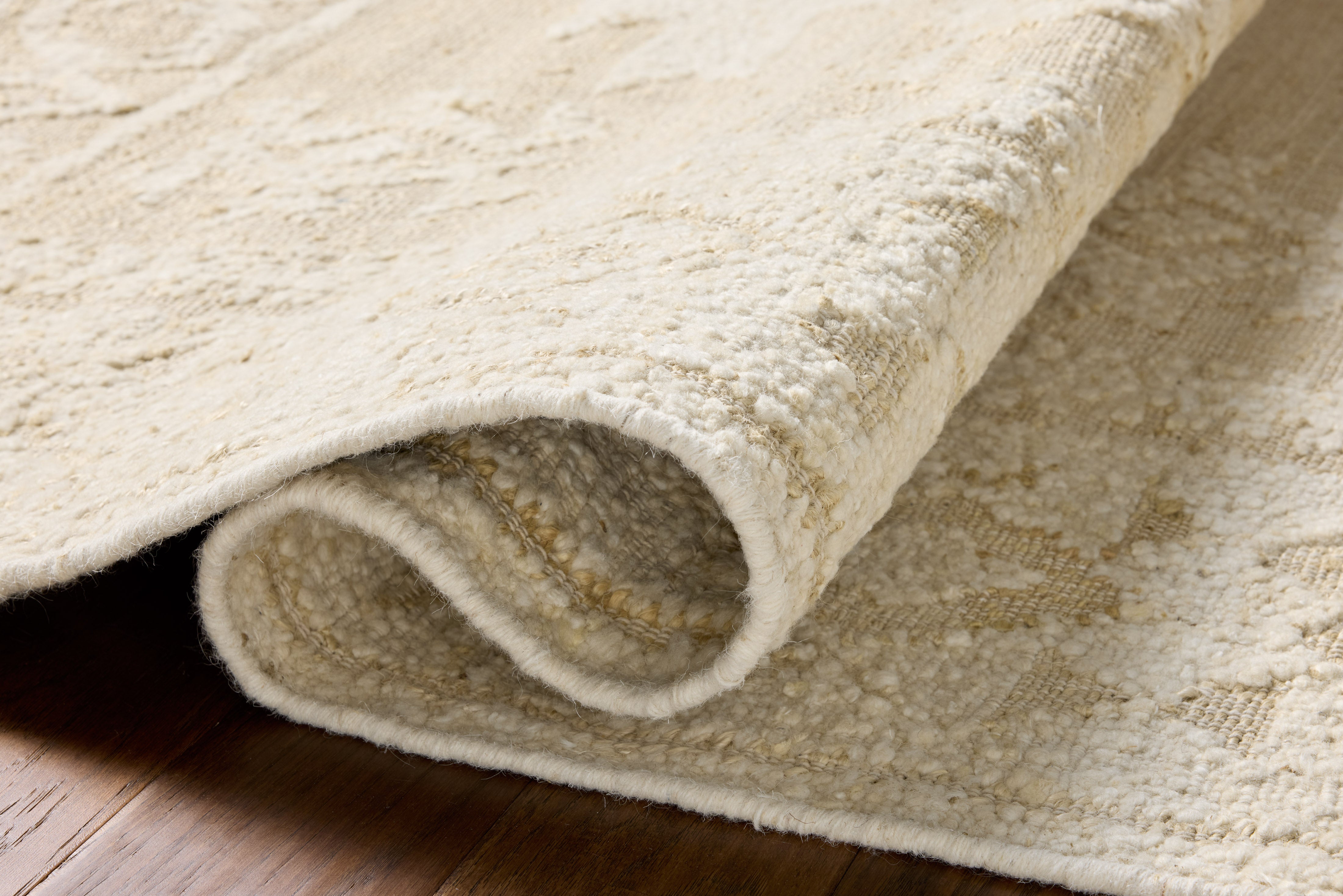 A stunning hand-woven wool area rug, the Alara ALR-01 Ivory / Natural Area Rug features refined ivory and warm natural tones for a polished look