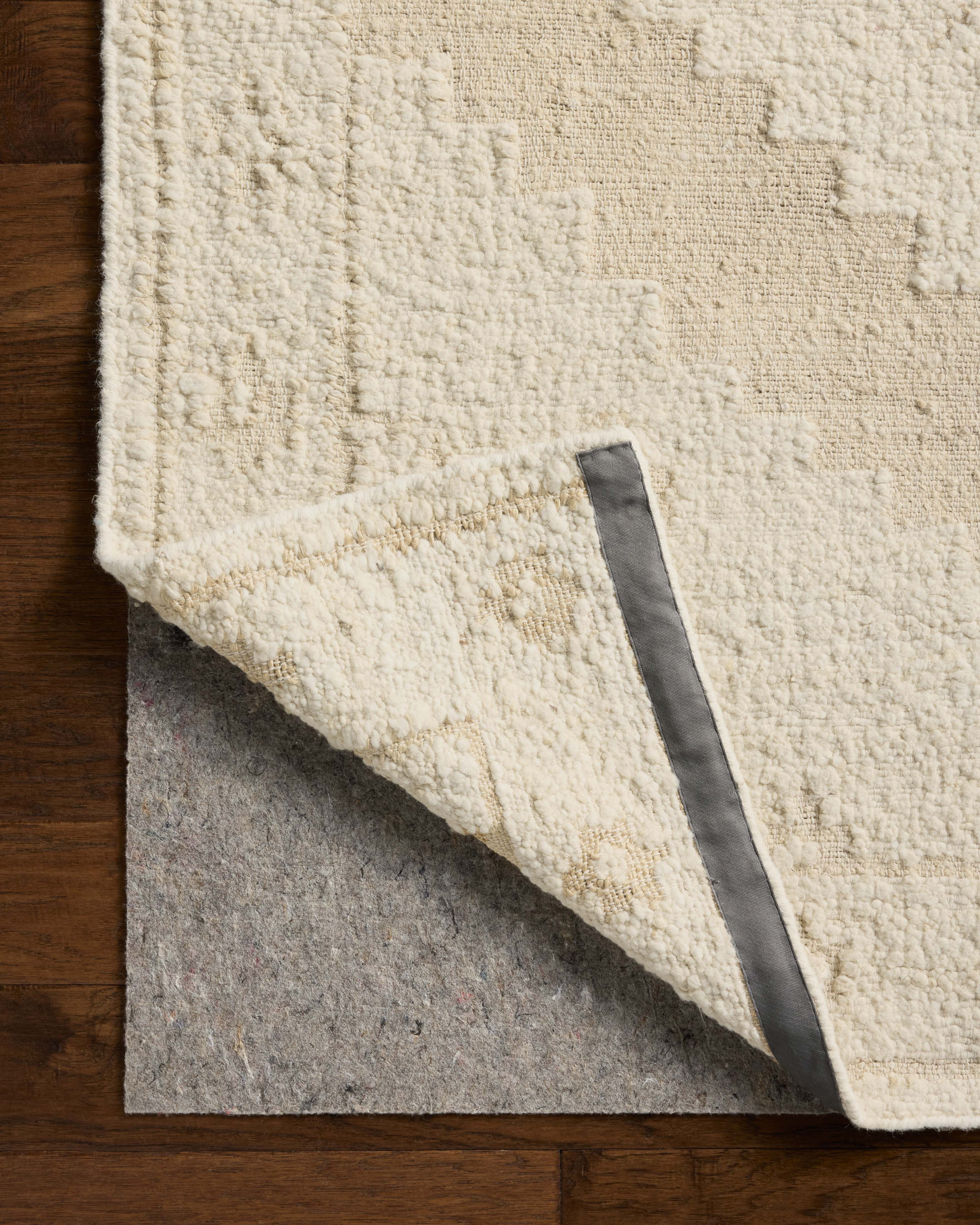 Designed in refined ivory and warm natural hues, the Alara ALR-03 Ivory / Natural Area Rug is a hand-woven wool area rug that stands out