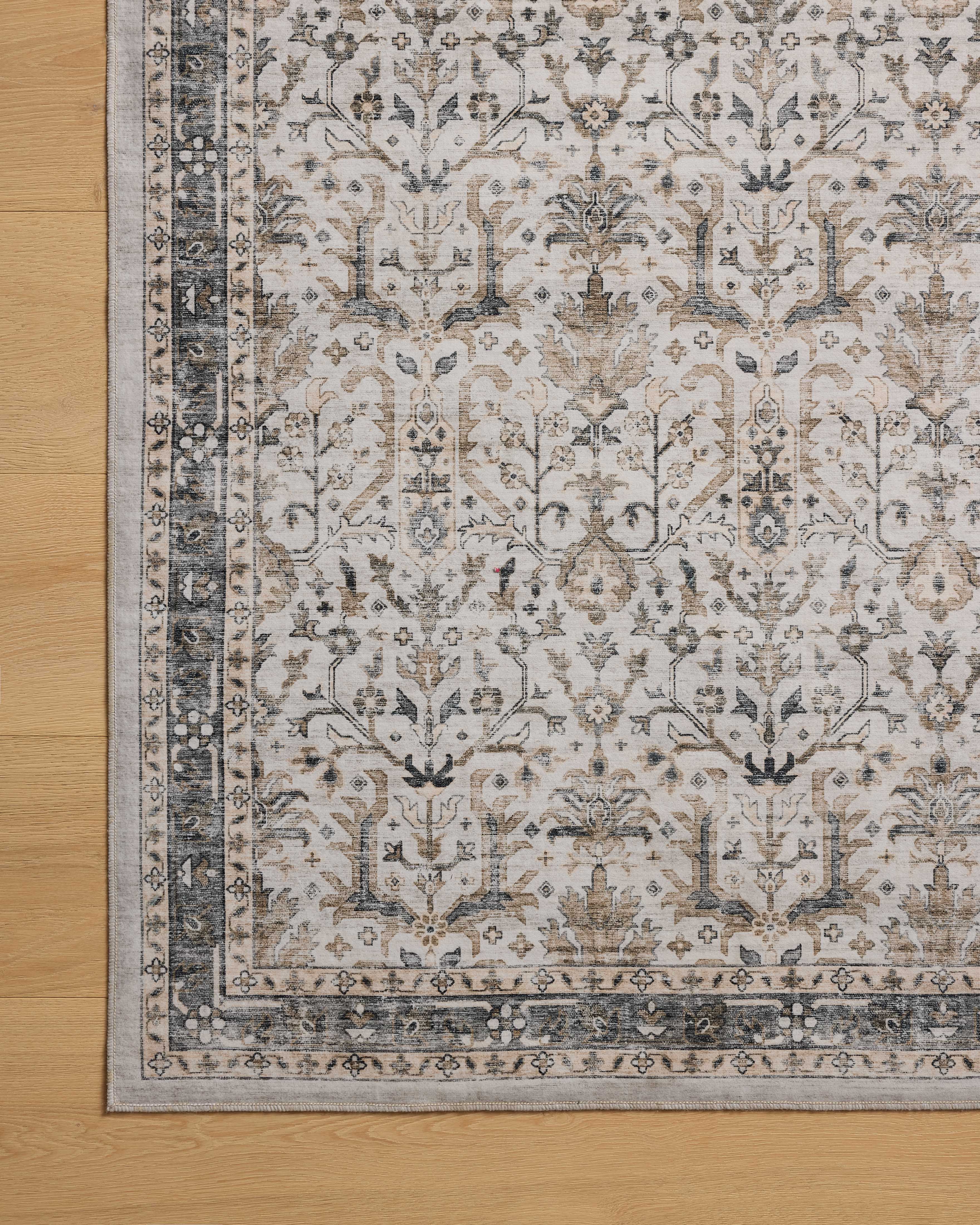 A power-loomed polyester area rug in refined ivory and grounding stone tones with traditional and distressed motifs, the Anniston ANS-01 Ivory / Stone Area Rug grounds your room beautifully