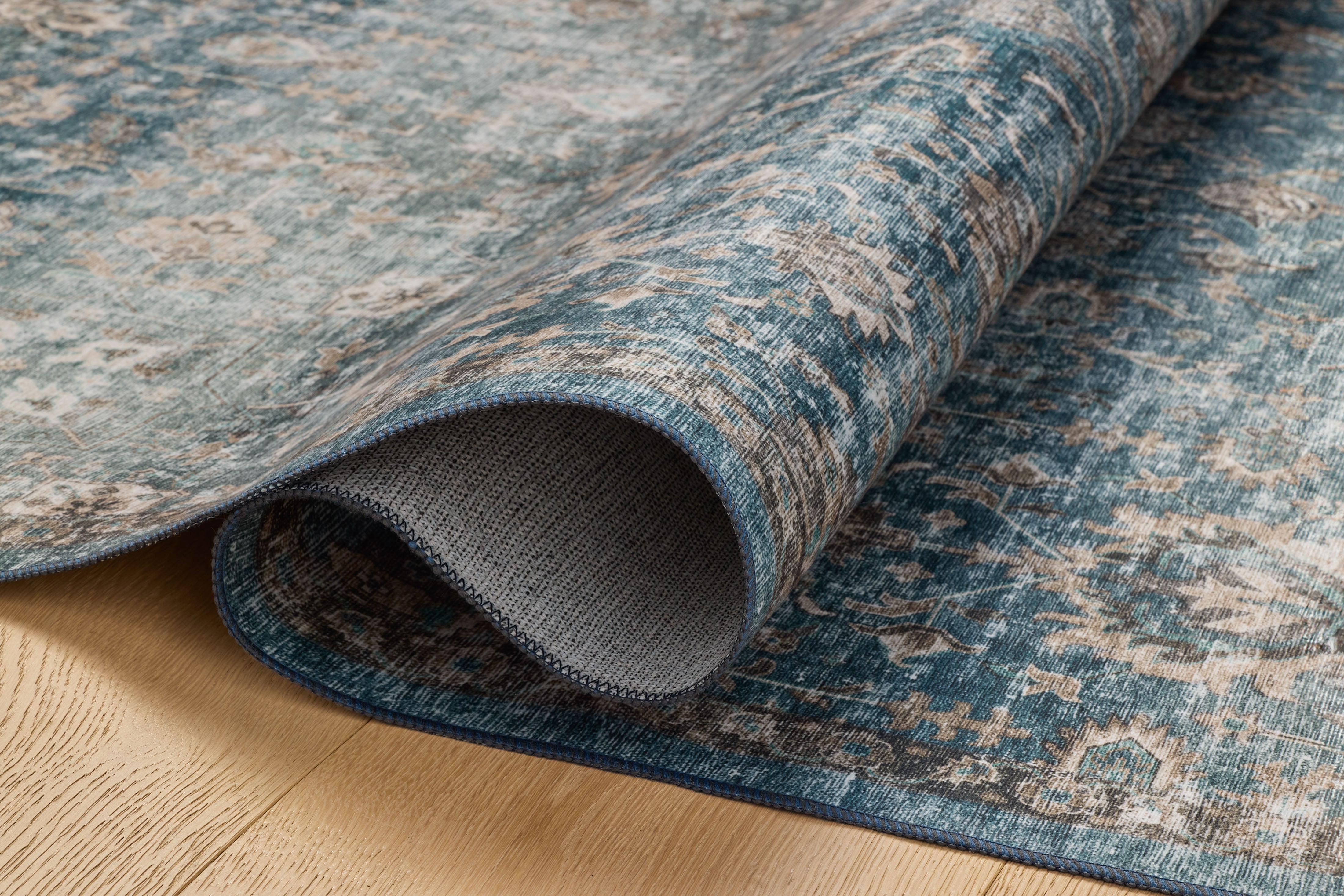 The Anniston ANS-02 Lagoon / Natural Area Rug is a power-loomed polyester area rug that radiates tranquil lagoon and warm natural charm and traditional and distressed elegance