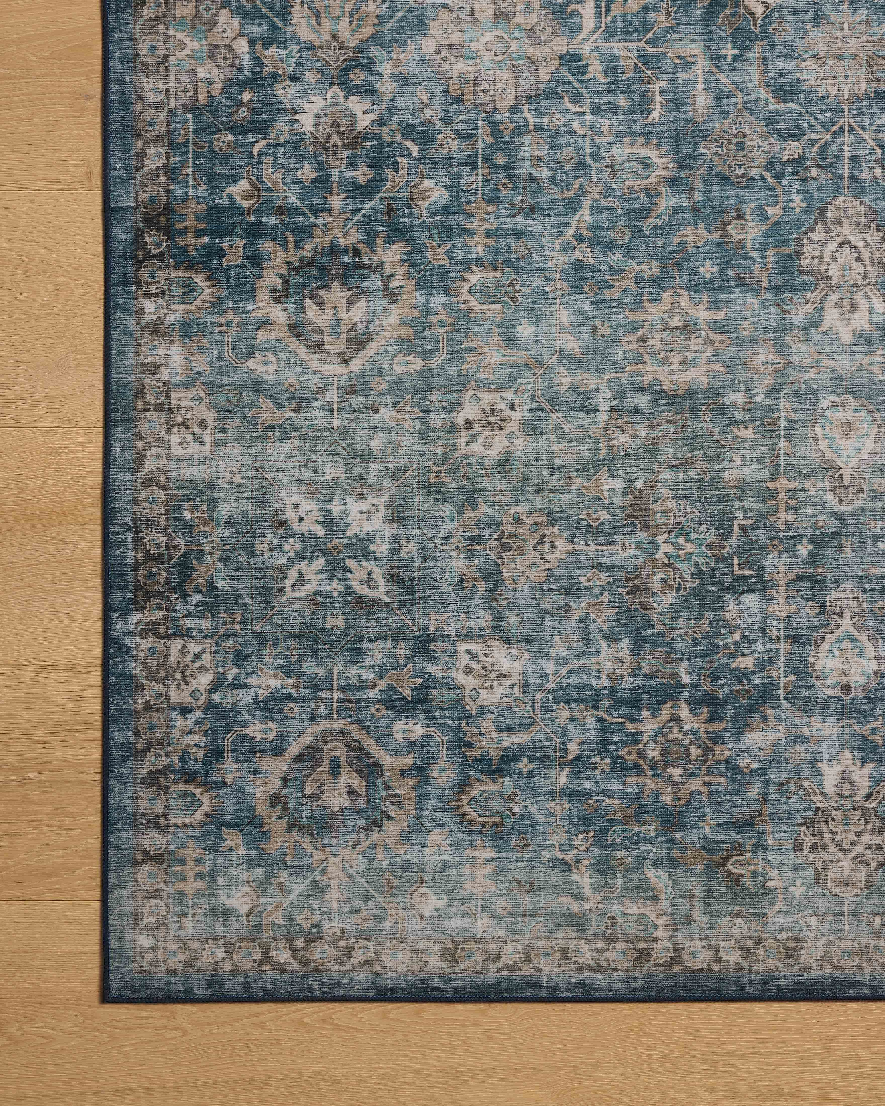 The Anniston ANS-02 Lagoon / Natural Area Rug is a power-loomed polyester area rug that radiates tranquil lagoon and warm natural charm and traditional and distressed elegance