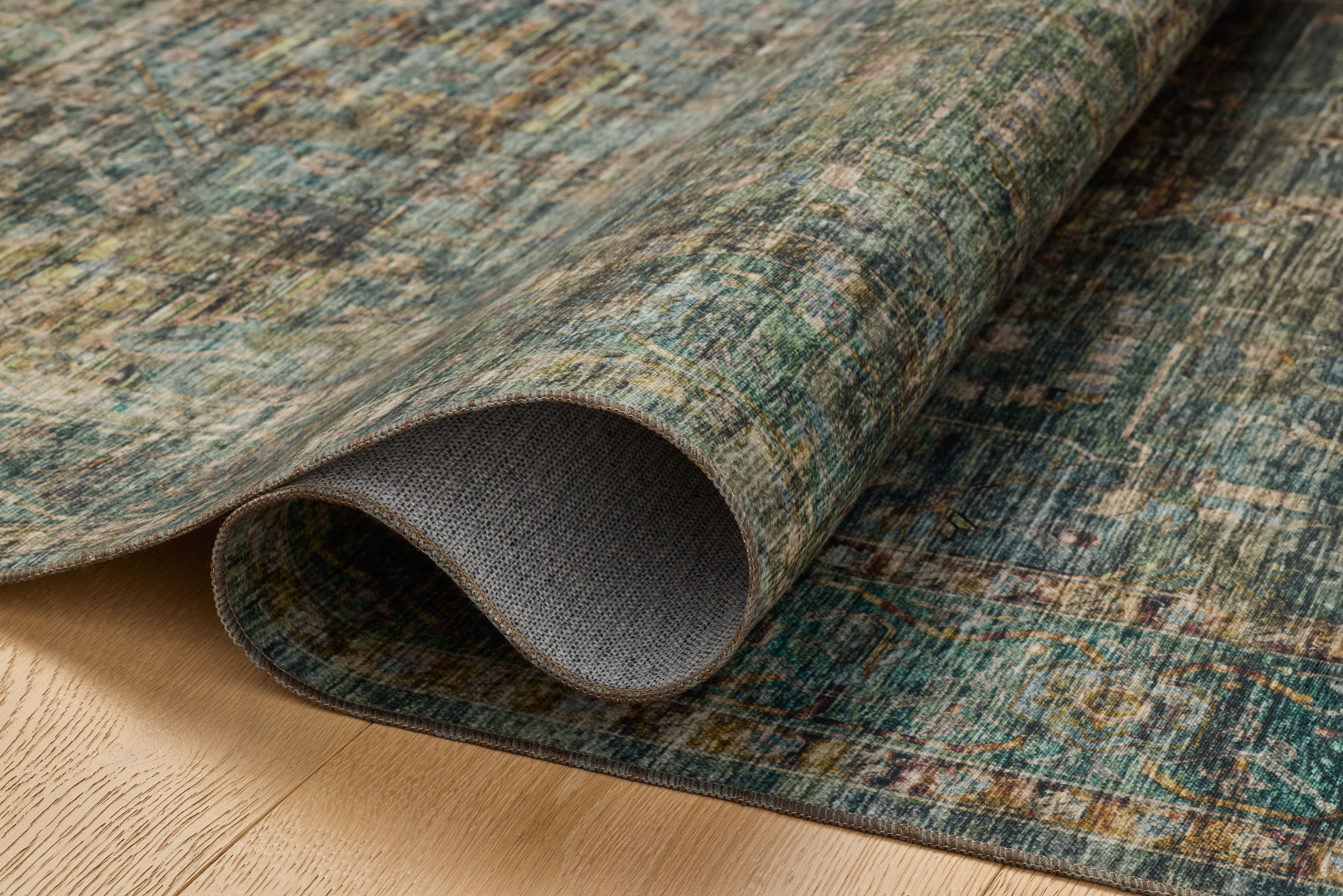Featuring tranquil lagoon and vibrant multi-toned hues and traditional and distressed detail, the Anniston ANS-05 Lagoon / Multi Area Rug is a power-loomed polyester area rug for any room