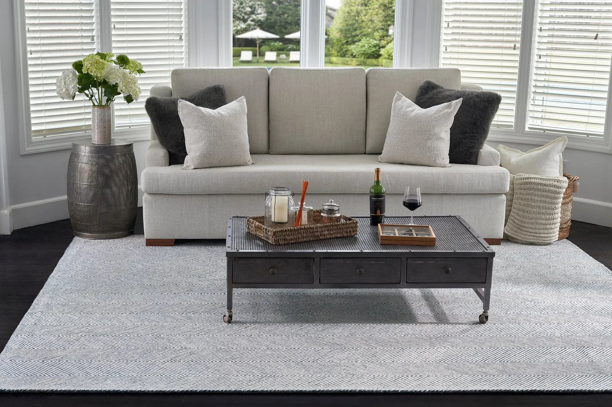 Charles CHR-1 Blue Area Rug with a white herringbone pattern under a sofa and coffee table.