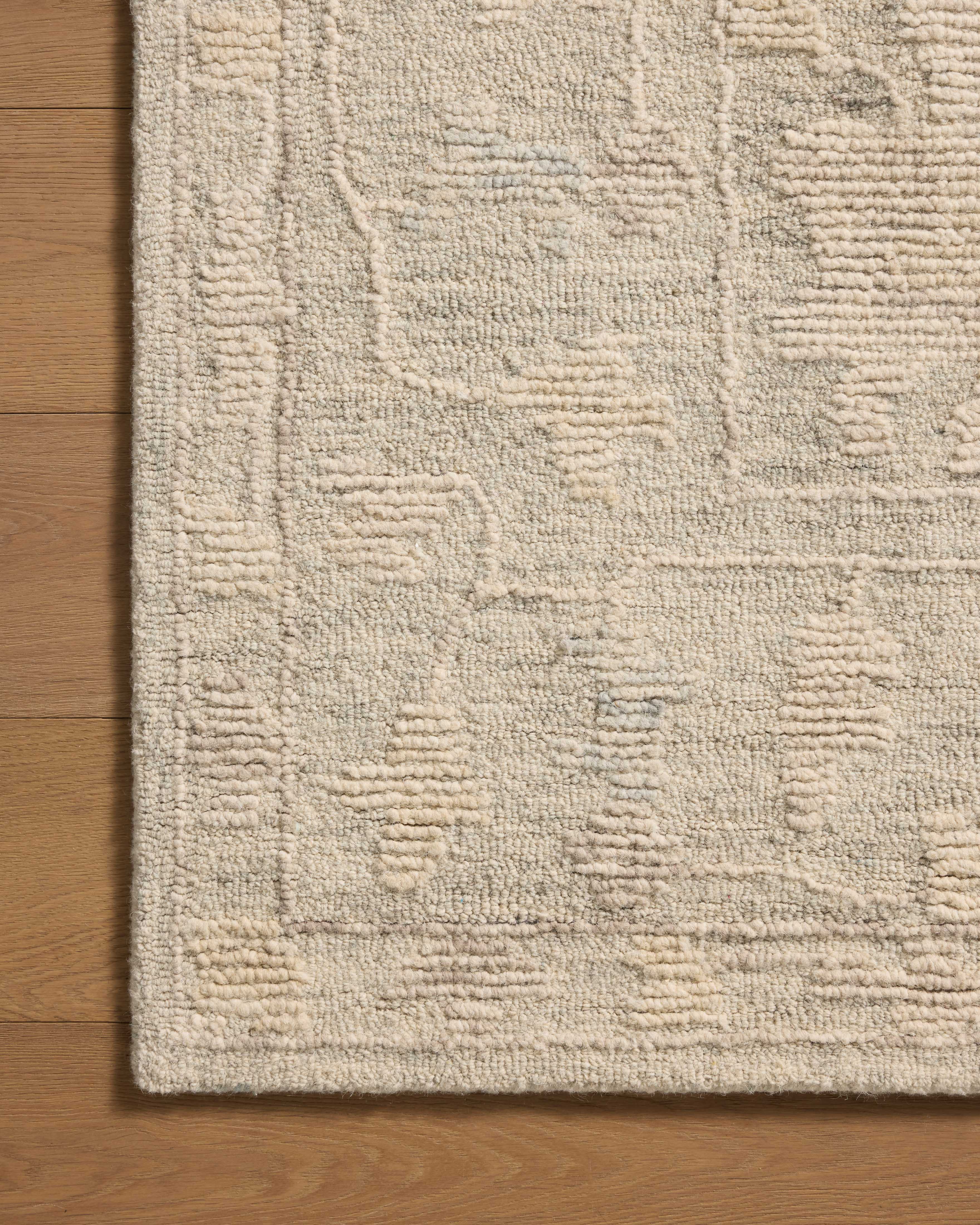 The Cynthia CYN-04 Sky / Natural Area Rug pairs breezy sky-blue and warm natural tones and floral patterns in a hand-tufted wool area rug