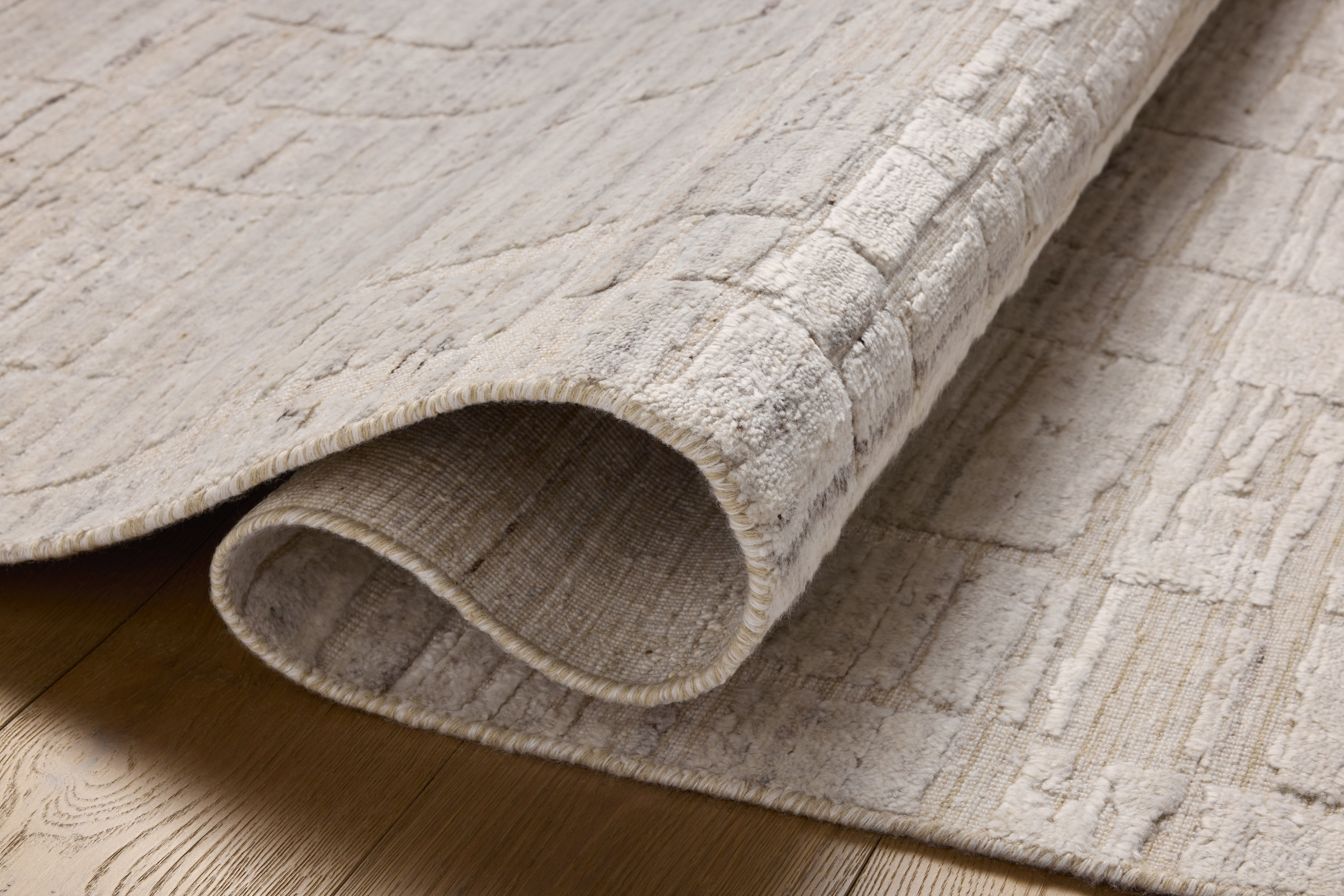 Rich in antique ivory hues with ribbed and graphic detail, the Daniel DAN-01 Antique Ivory Area Rug is a hand-loomed bamboo and wool area rug built for style and comfort