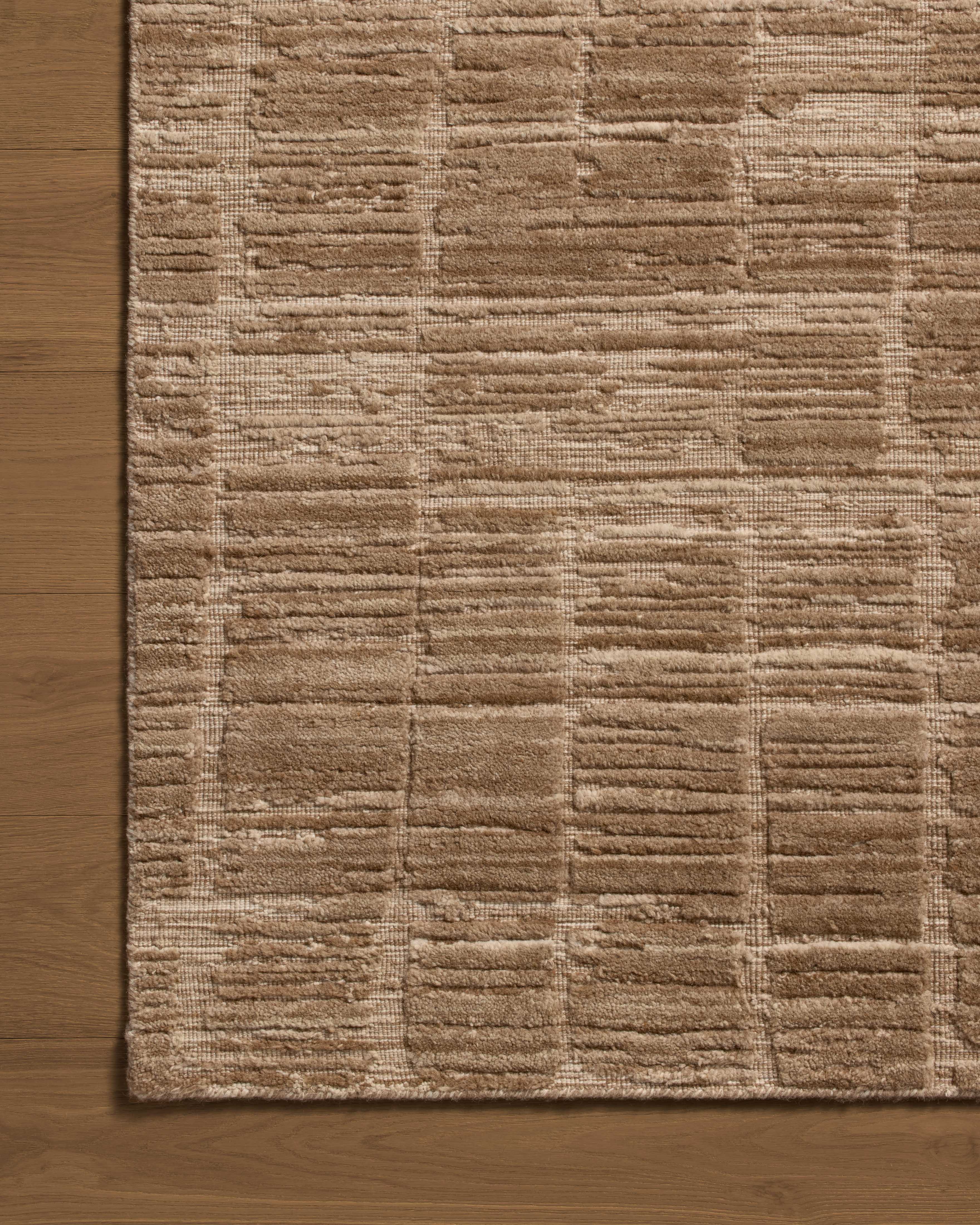 The Daniel DAN-01 Fawn Area Rug offers warm fawn sophistication and ribbed and graphic charm in a hand-loomed bamboo and wool area rug