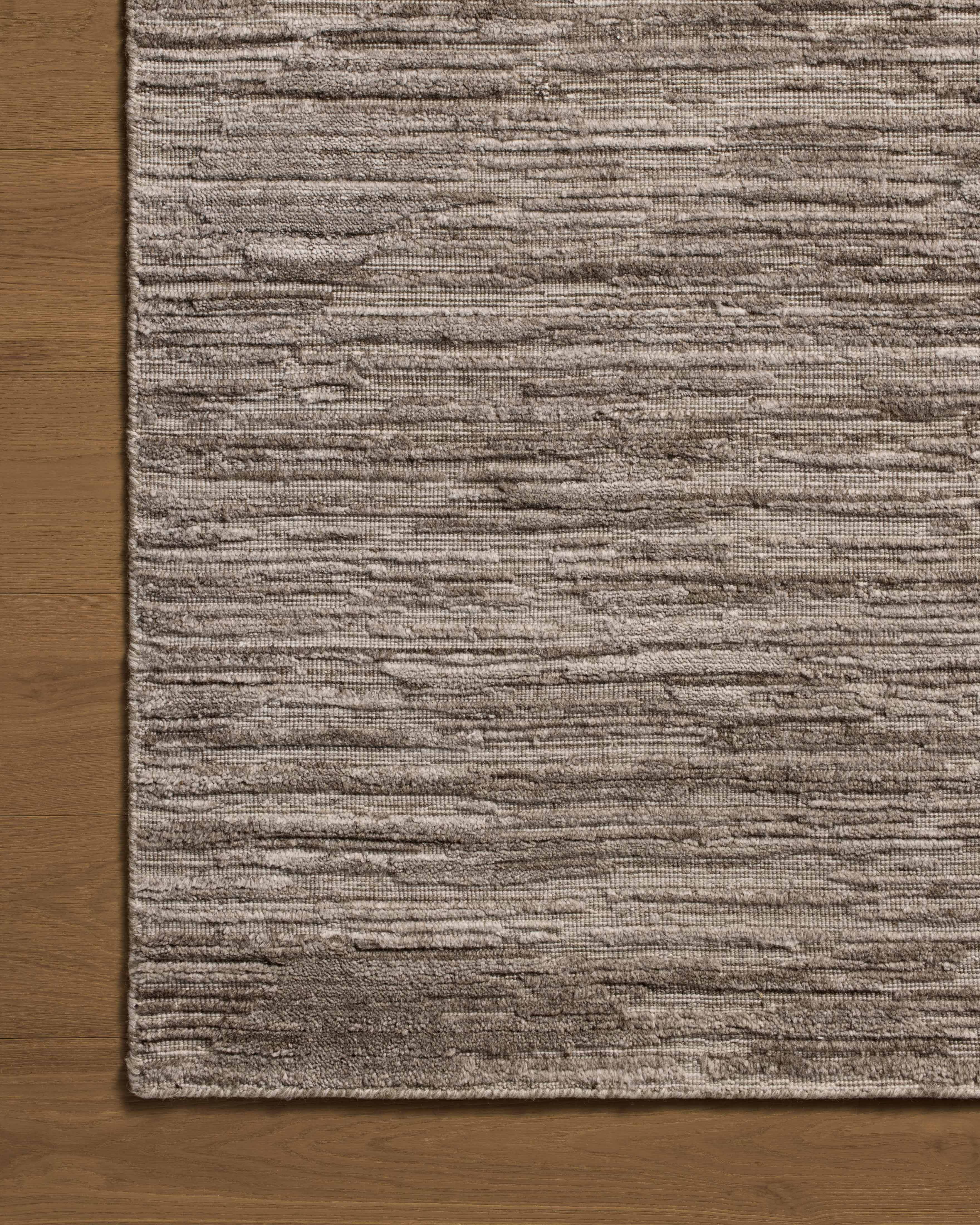 The Daniel DAN-02 Dove Area Rug brings gentle dove character and ribbed and graphic flair to your home in a hand-loomed bamboo and wool area rug