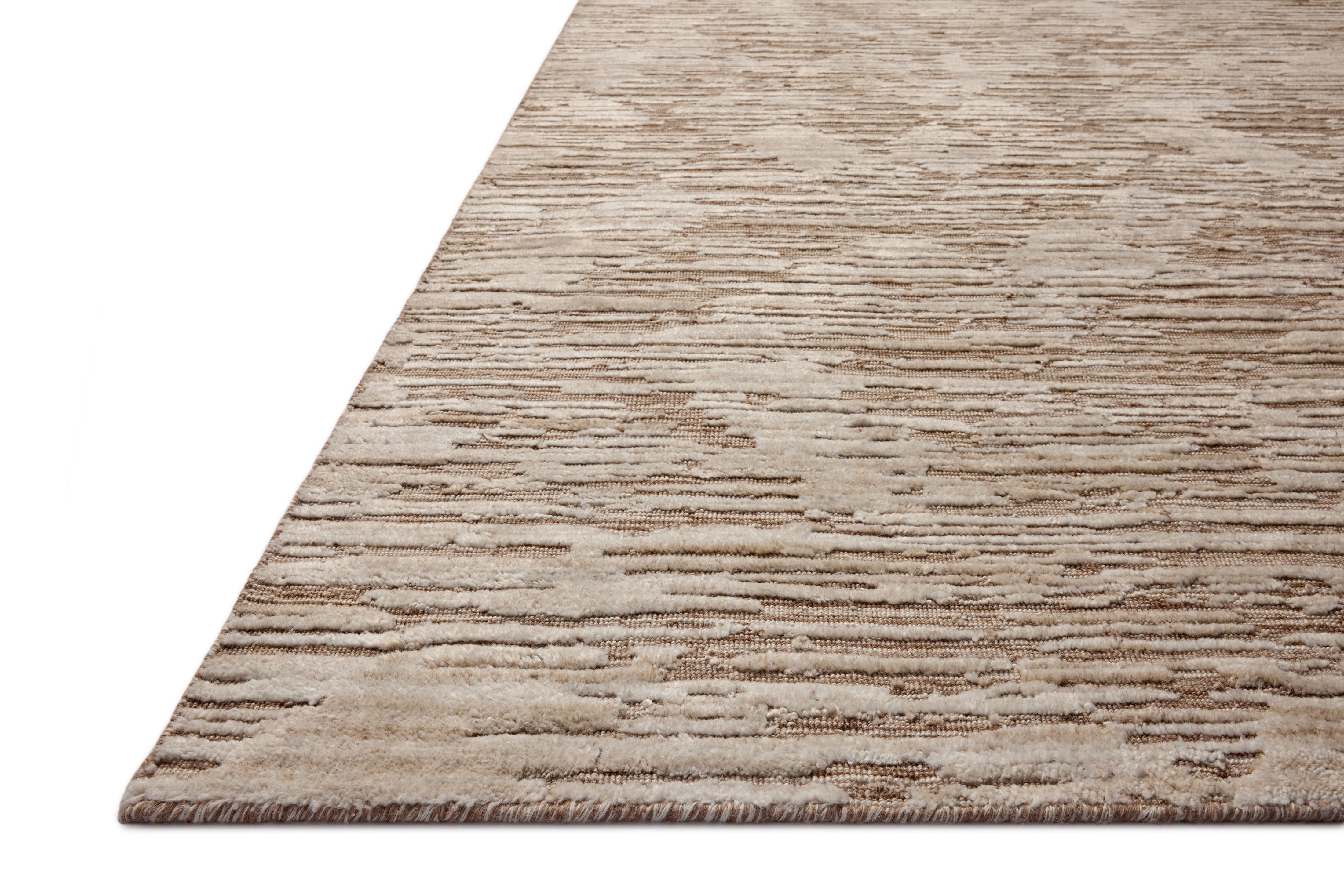 Finished in warm natural tones with ribbed and graphic styling, the Daniel DAN-02 Natural Area Rug is a hand-loomed bamboo and wool area rug for modern living