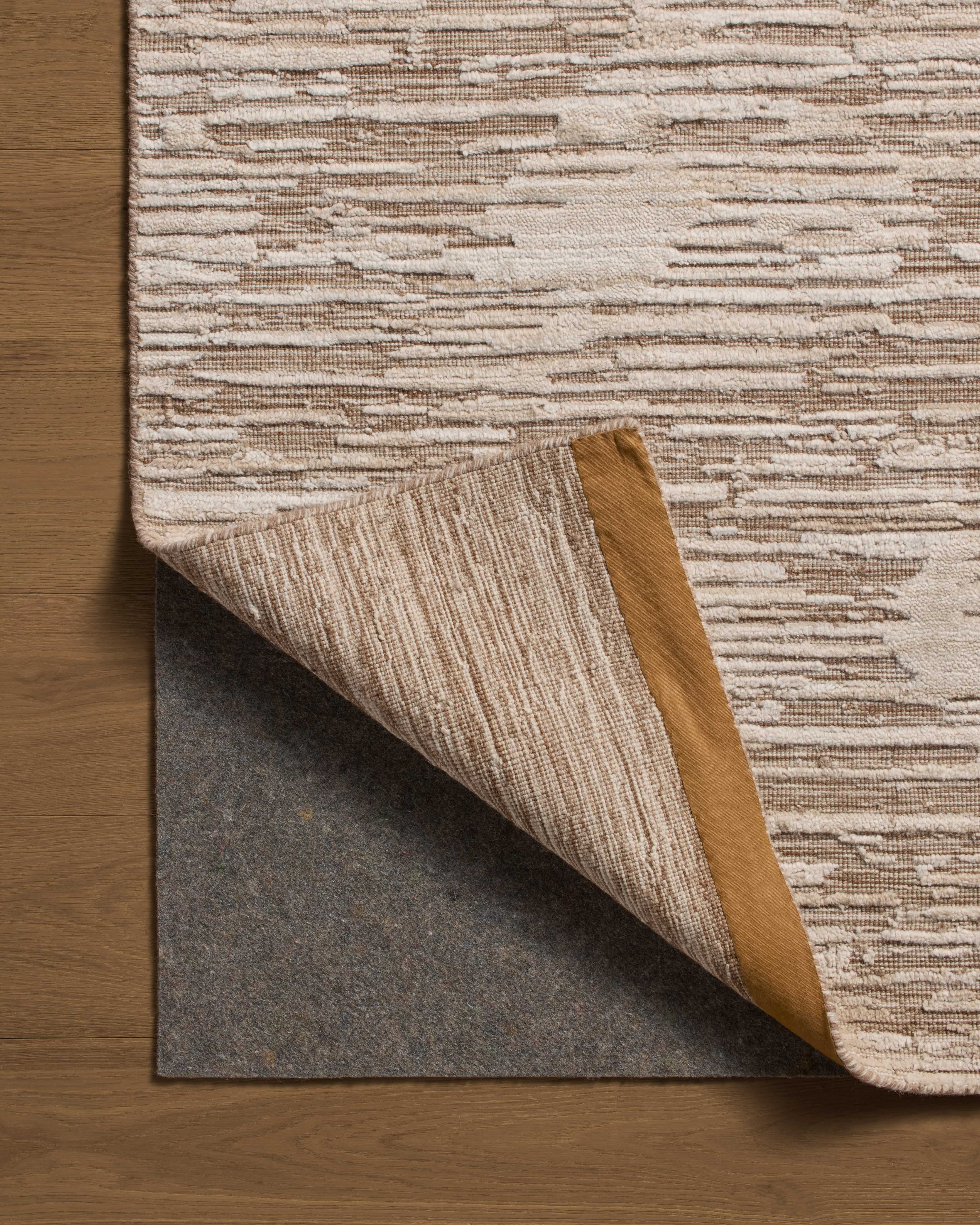 Finished in warm natural tones with ribbed and graphic styling, the Daniel DAN-02 Natural Area Rug is a hand-loomed bamboo and wool area rug for modern living