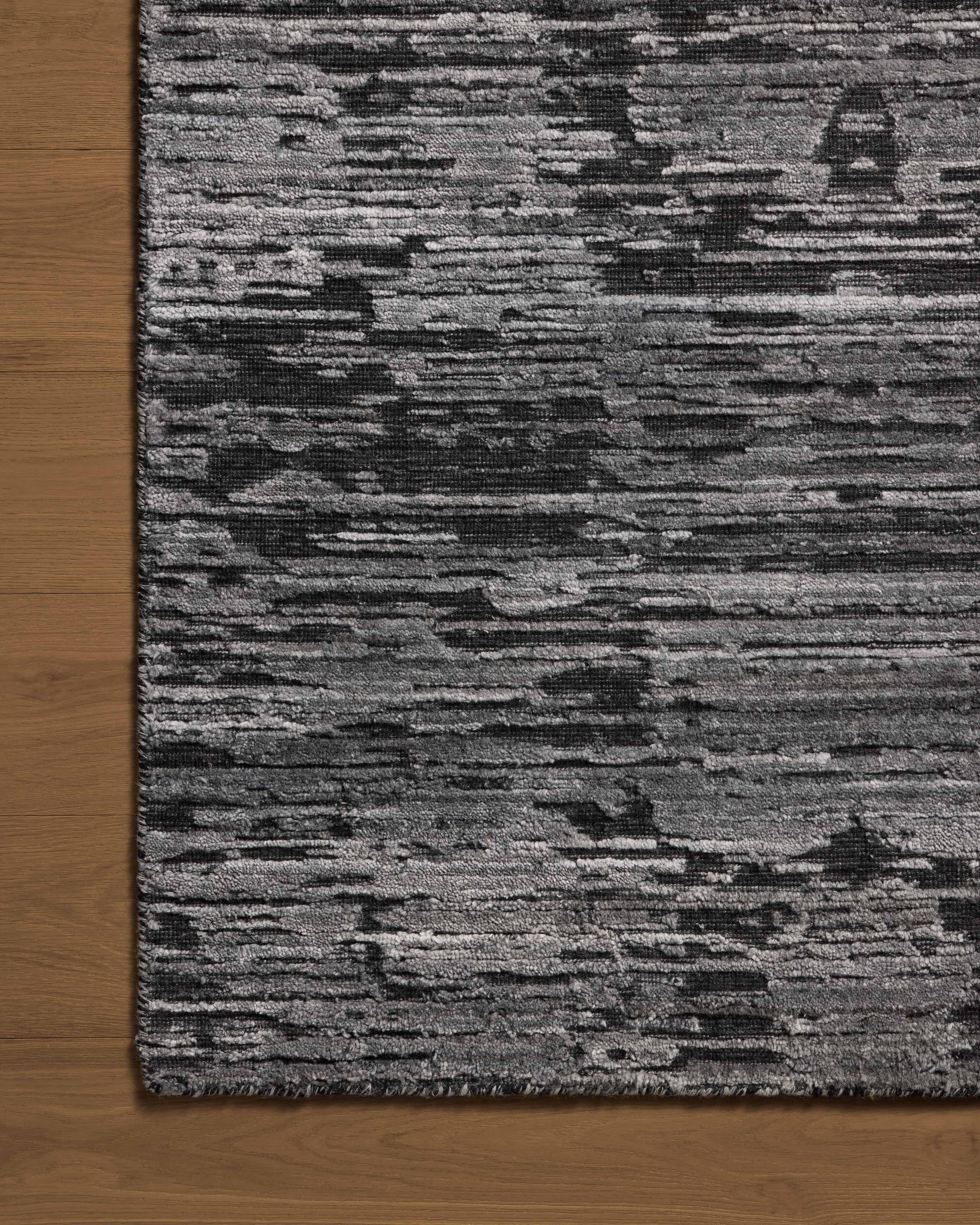 A hand-loomed bamboo and wool area rug with ribbed and graphic design in deep charcoal hues, the Daniel DAN-03 Charcoal Area Rug is a standout in any décor