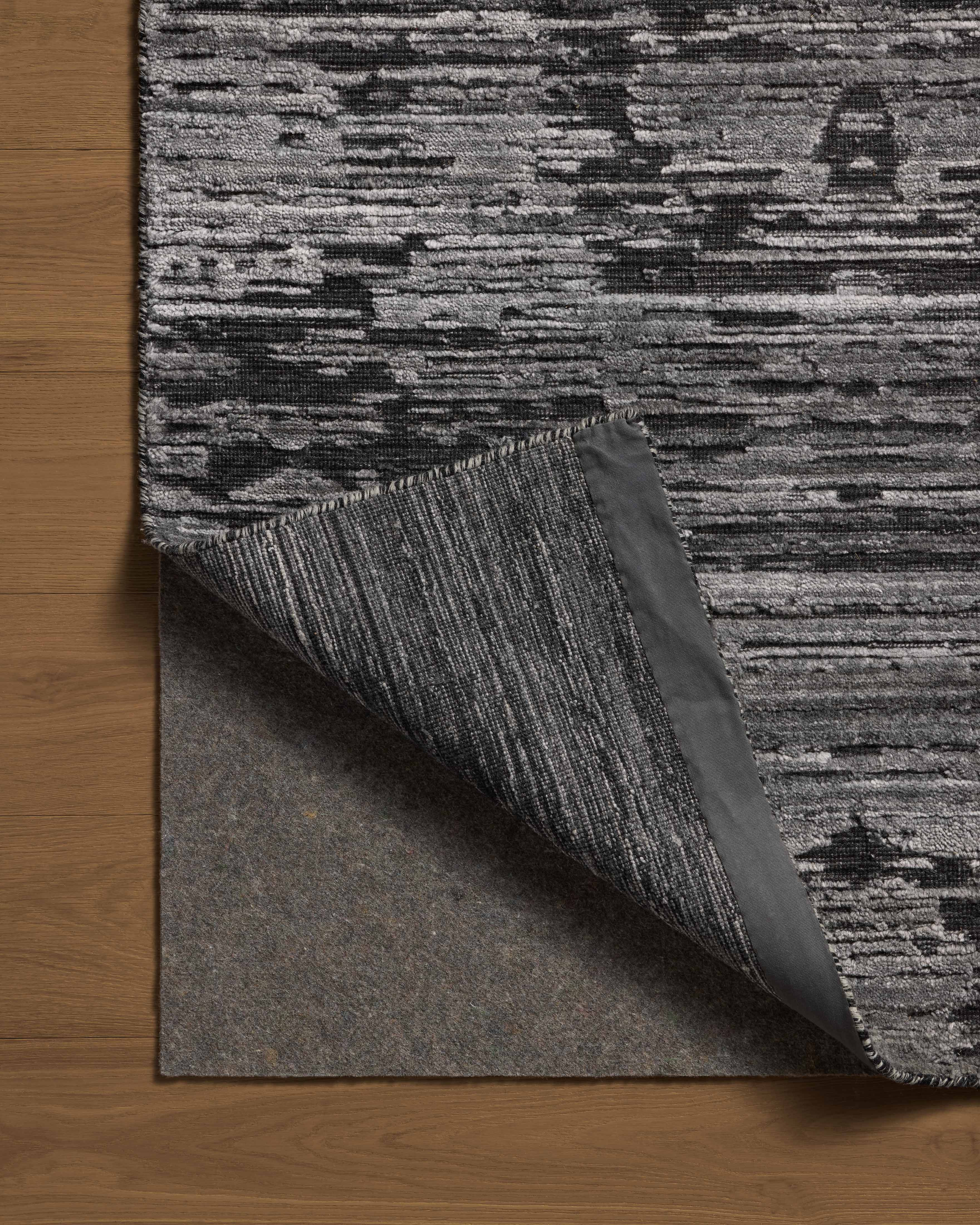 A hand-loomed bamboo and wool area rug with ribbed and graphic design in deep charcoal hues, the Daniel DAN-03 Charcoal Area Rug is a standout in any décor