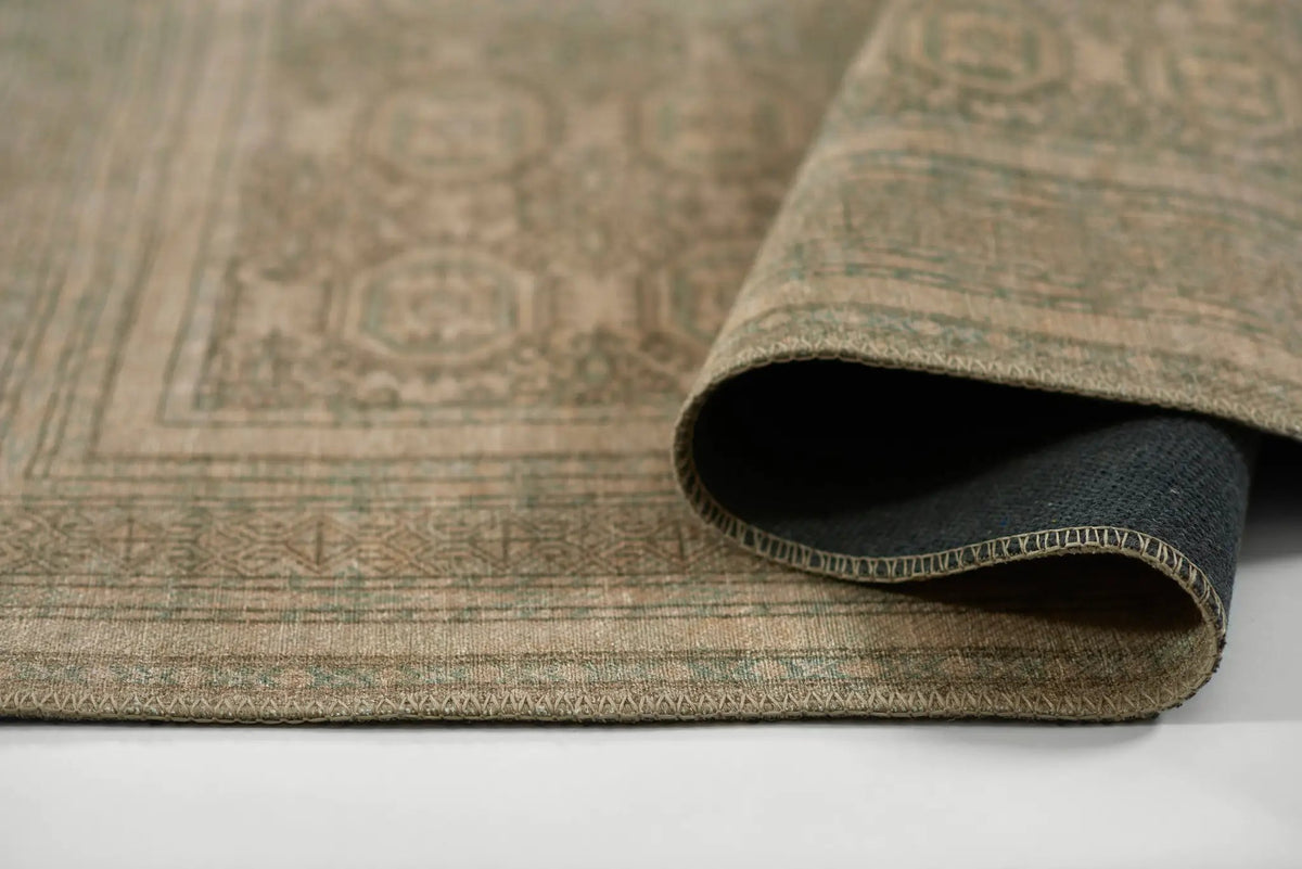 Erin Gates by Momeni Dorset DOR-1 green area rug featuring vintage-inspired pattern, rolled corner showing durable backing and detailed border.
