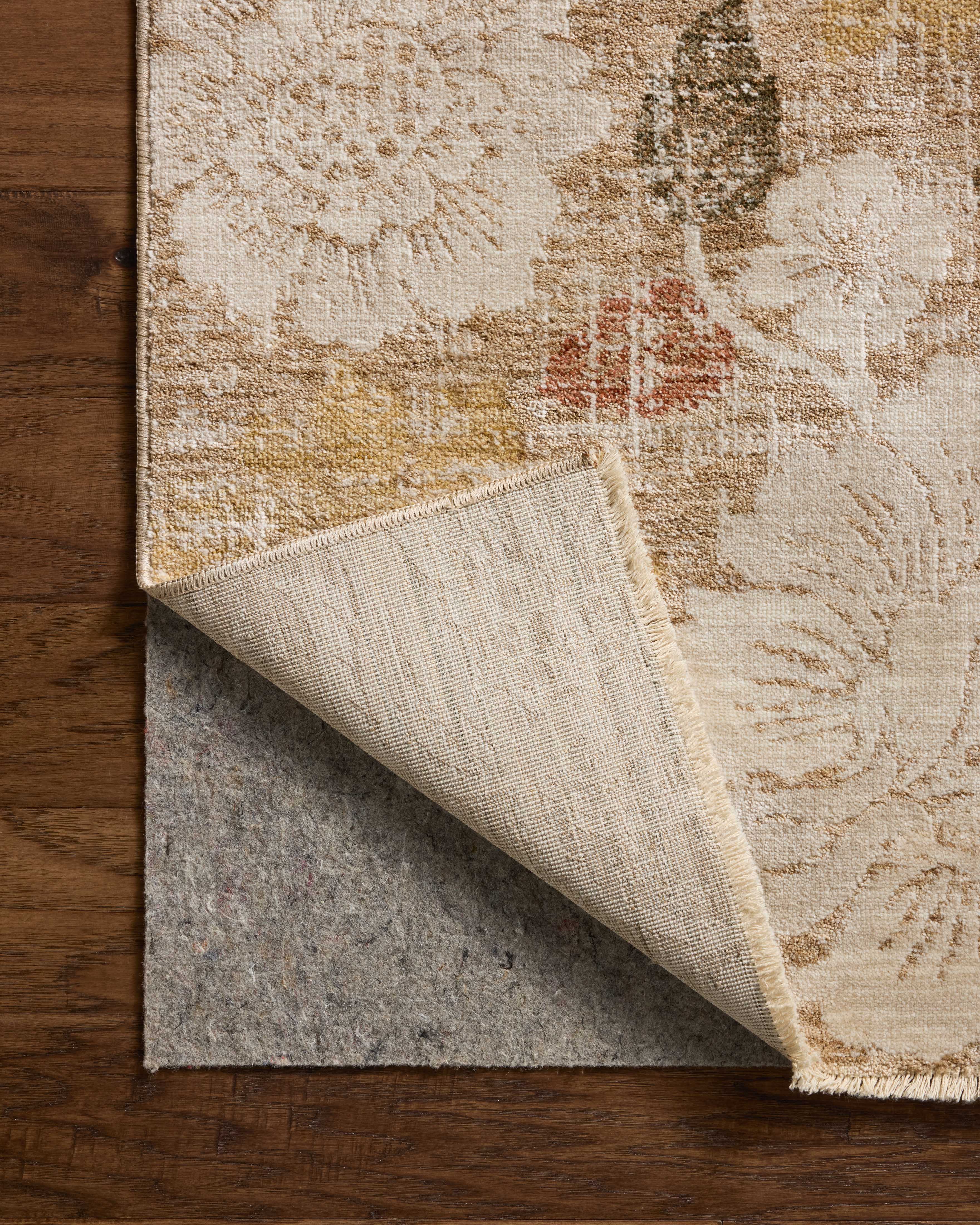 A power-loomed polypropylene and polyester area rug with botanical flair in warm natural and vibrant multi-toned tones, the Eileen ELE-03 Natural / Multi Area Rug anchors any room