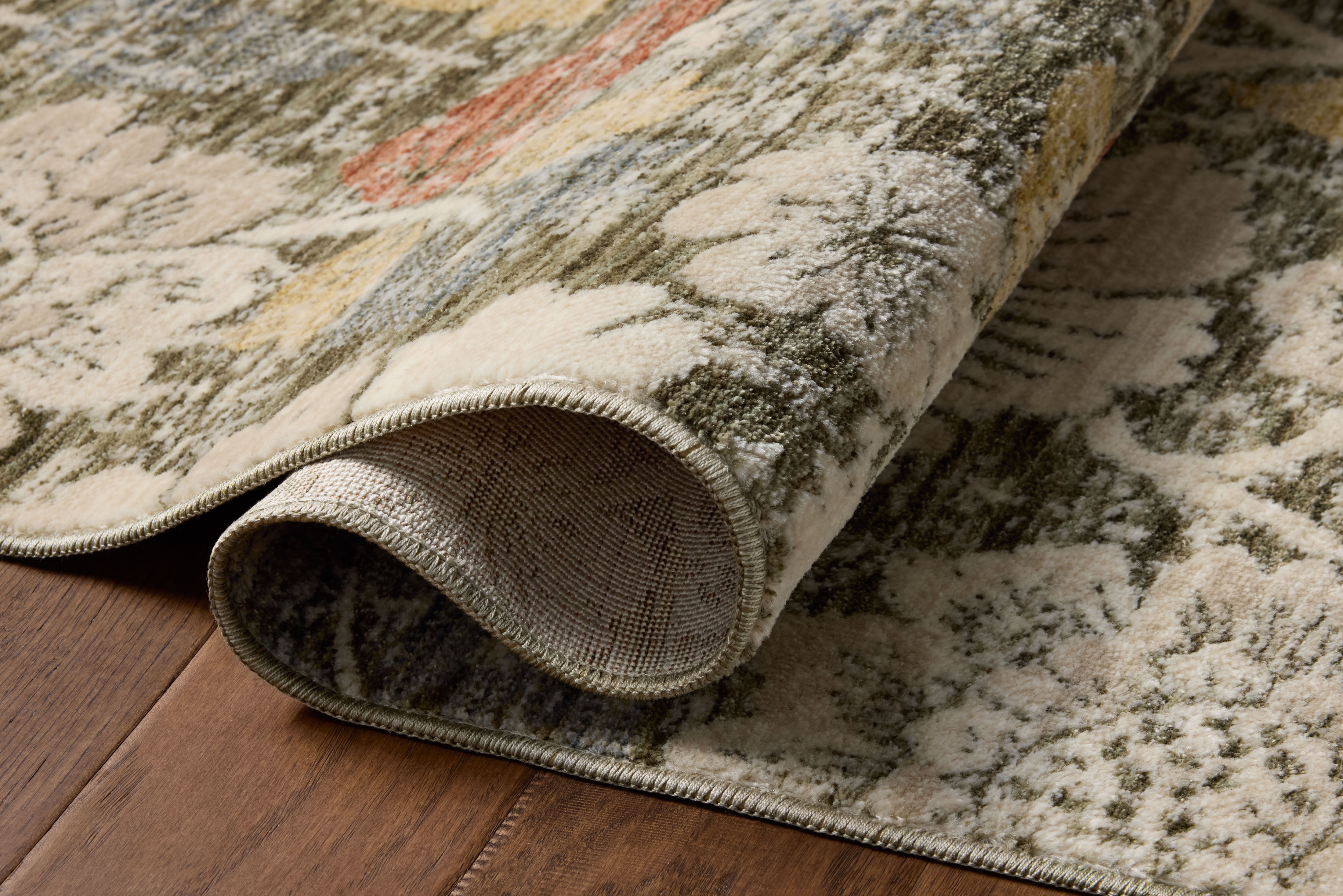The Eileen ELE-03 Olive / Multi Area Rug pairs earthy olive and vibrant multi-toned tones and botanical patterns in a power-loomed polypropylene and polyester area rug