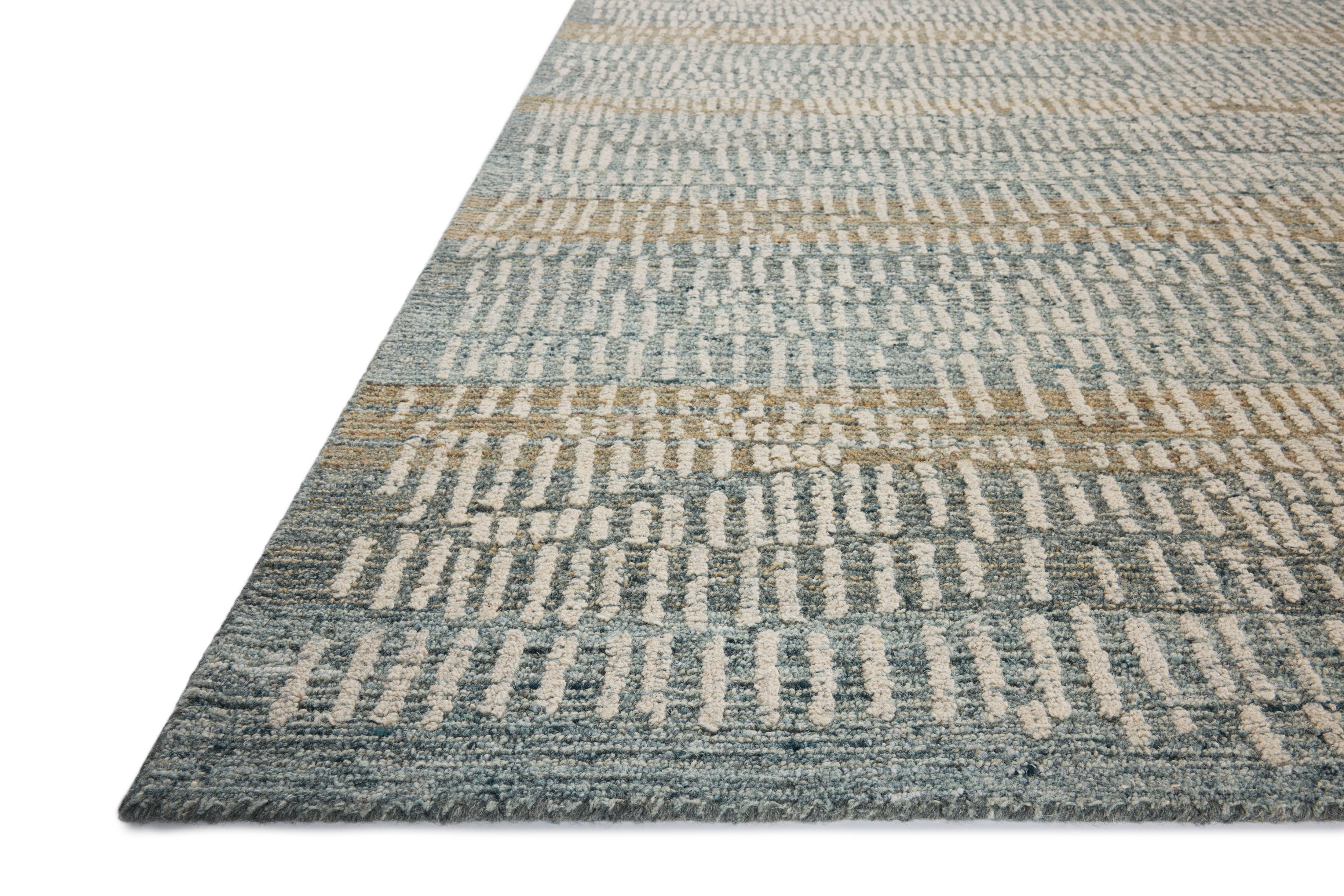 The Elias ELA-02 Ocean / Oatmeal Area Rug combines serene ocean and cozy oatmeal tones and graphic and high-low textured patterns in a hand-tufted wool area rug for effortless elegance