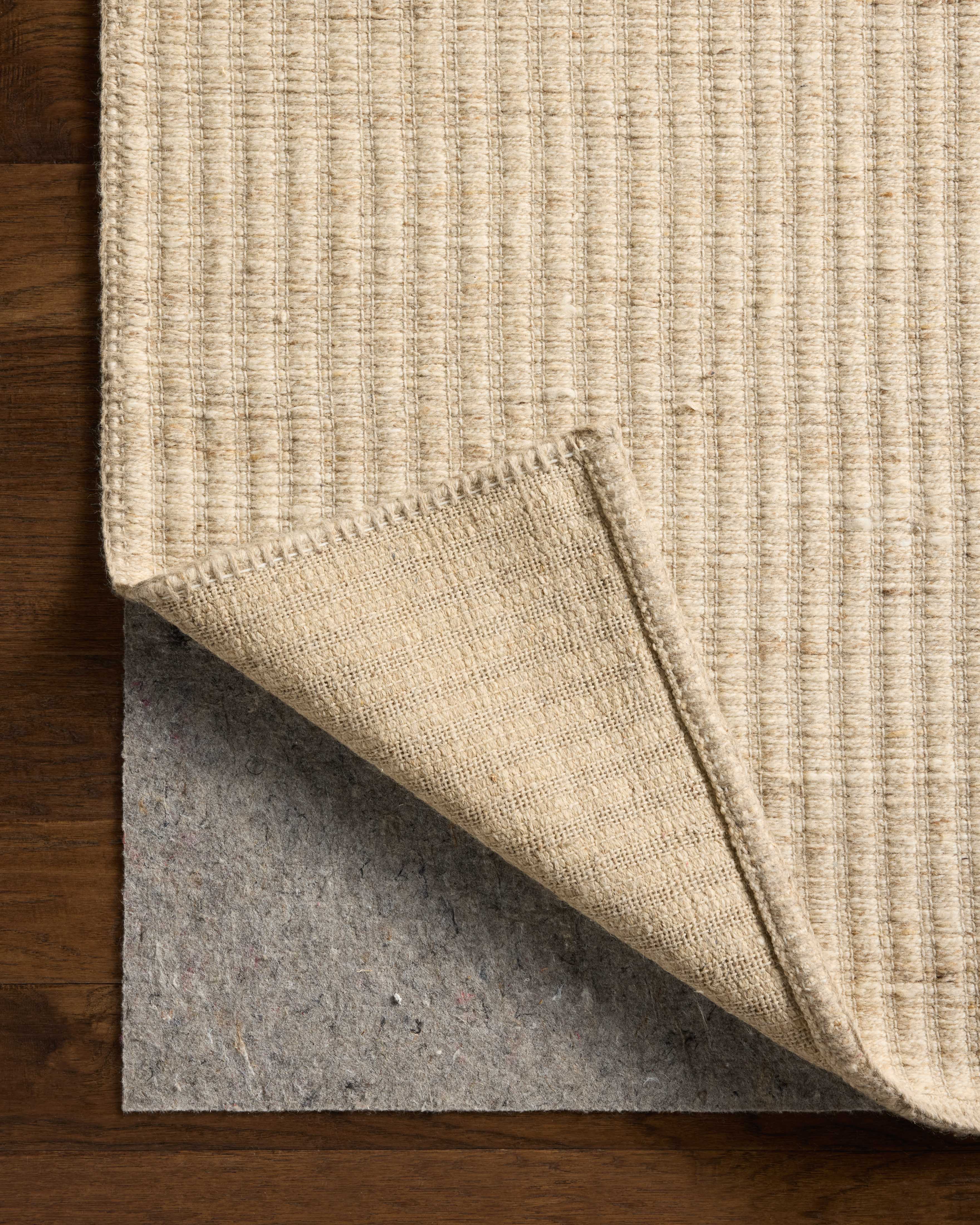 The Elma ELM-01 Bone Area Rug blends bone tones and striped motifs into a hand-woven wool and cotton area rug with timeless appeal