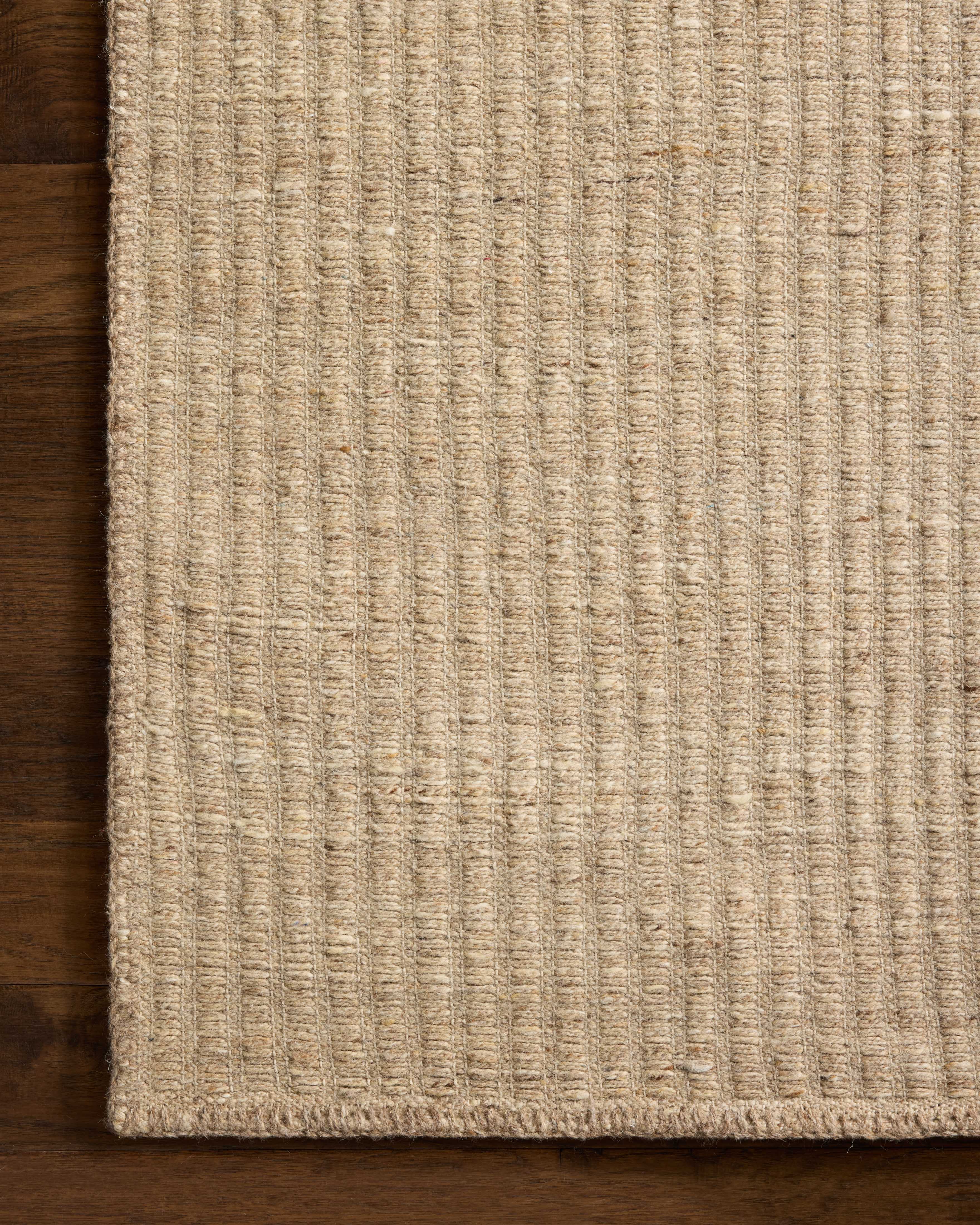 Designed with striped artistry in warm natural hues, the Elma ELM-01 Natural Area Rug is a hand-woven wool and cotton area rug that stands out