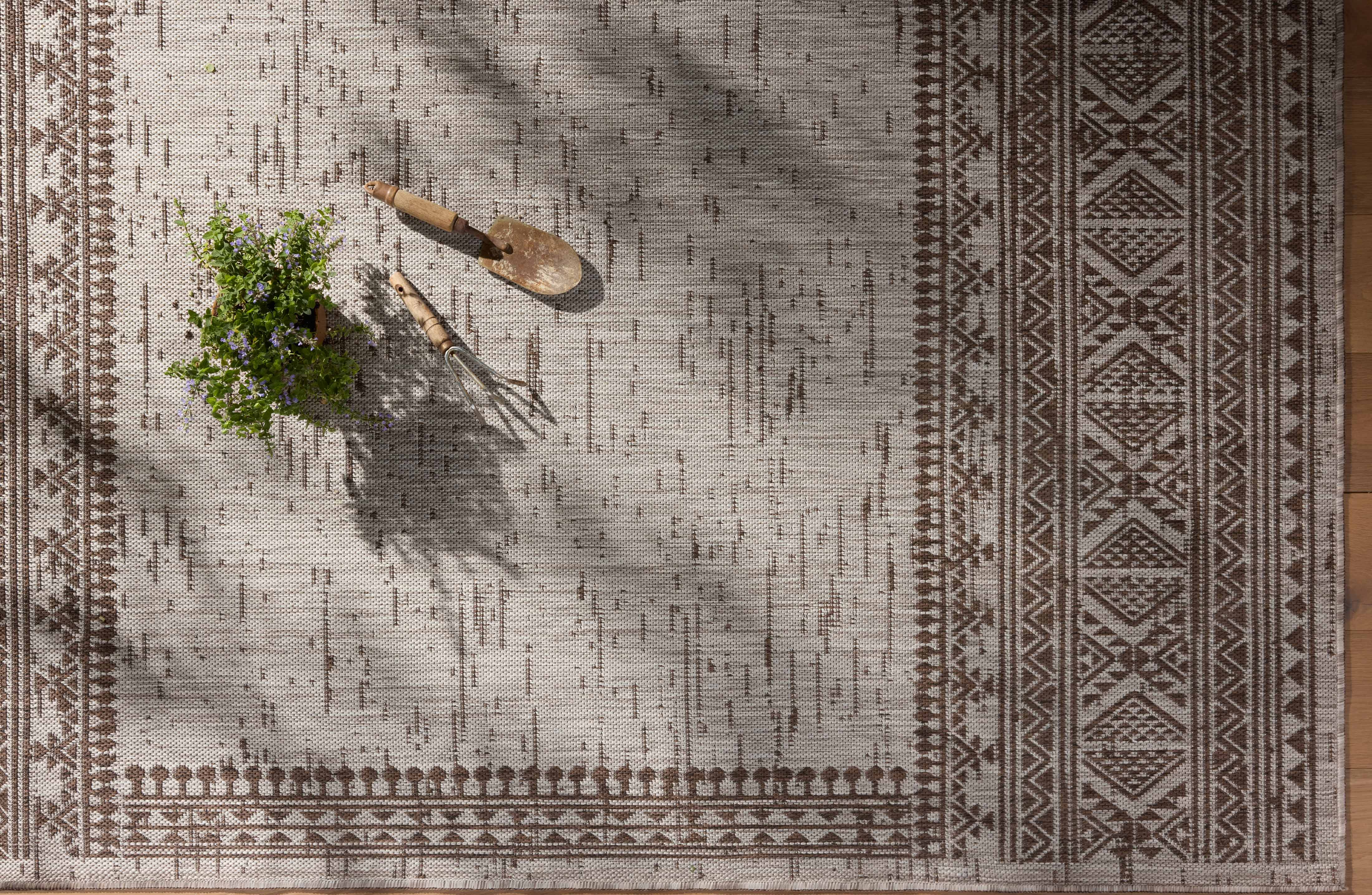 With coffee and gentle dove hues, the Easton ESN-01 Coffee / Dove Area Rug is a power-loomed polypropylene area rug that elevates any room