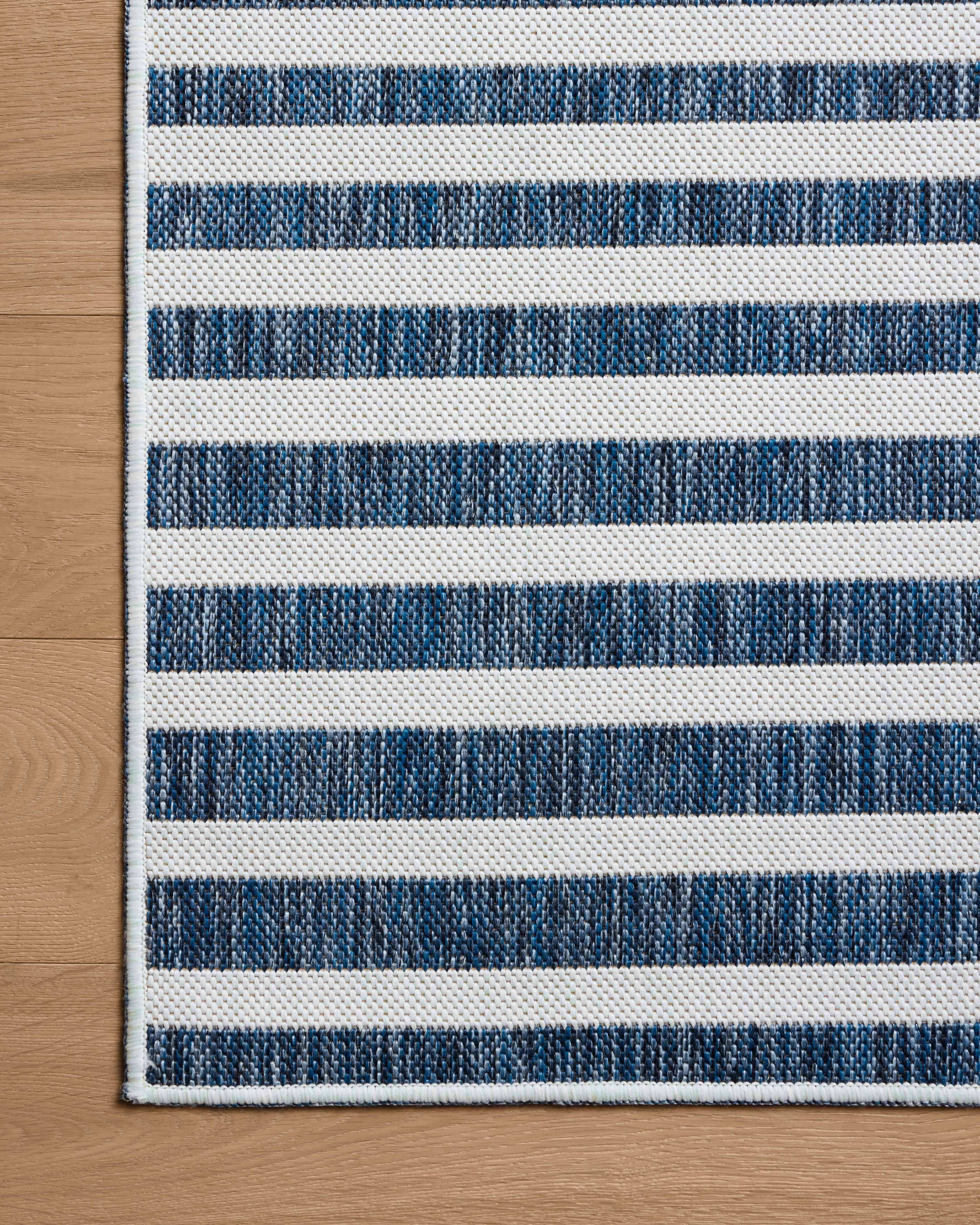 The Easton ESN-03 Denim / Ivory Area Rug delivers casual denim and refined ivory beauty in a power-loomed polypropylene area rug