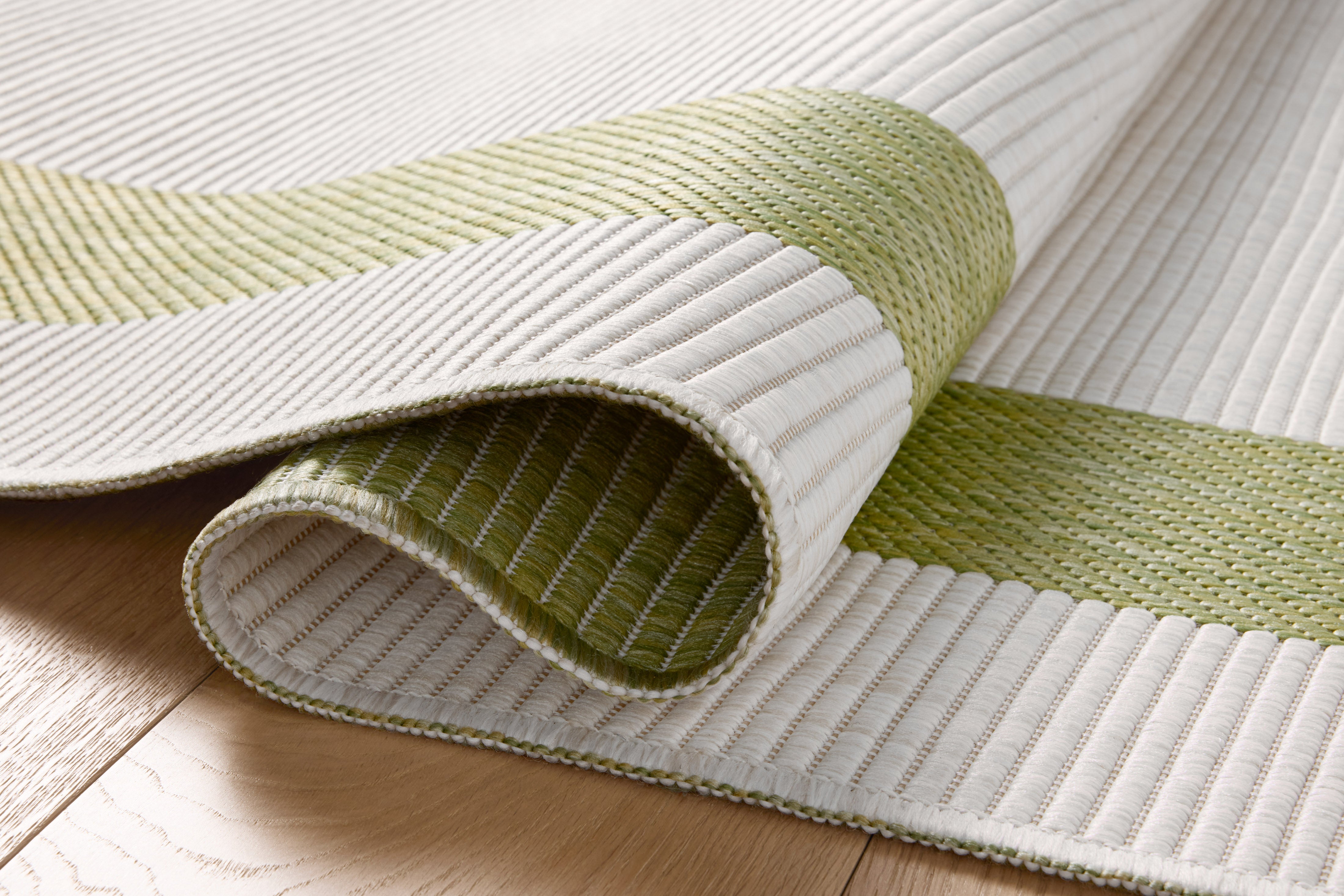 Rich in green and refined ivory hues, the Easton ESN-07 Green / Ivory Area Rug is a power-loomed polypropylene area rug built for style and comfort