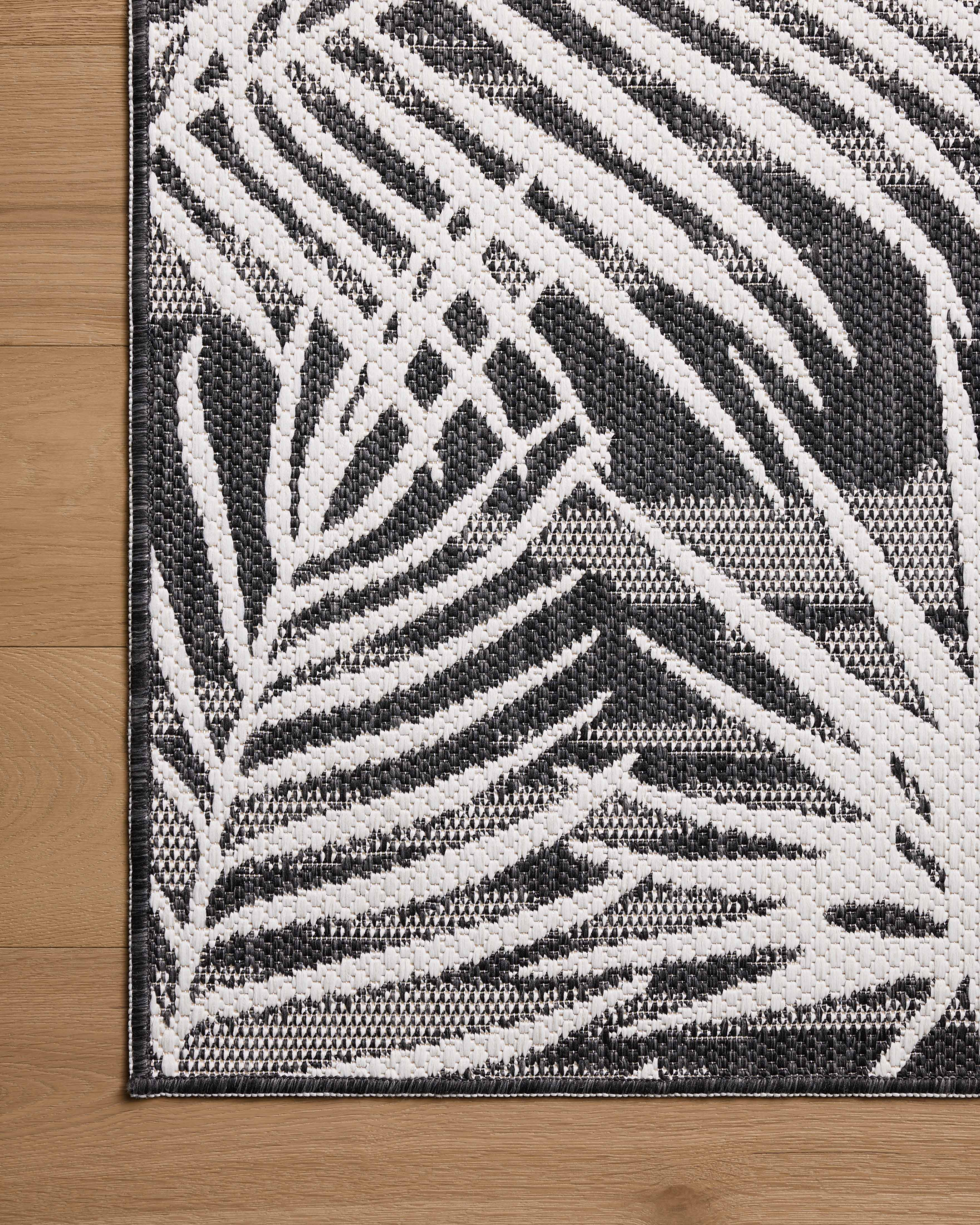 Expertly crafted as a power-loomed polypropylene area rug, the Easton ESN-09 Ivory / Onyx Area Rug captures refined ivory and bold onyx tones beautifully