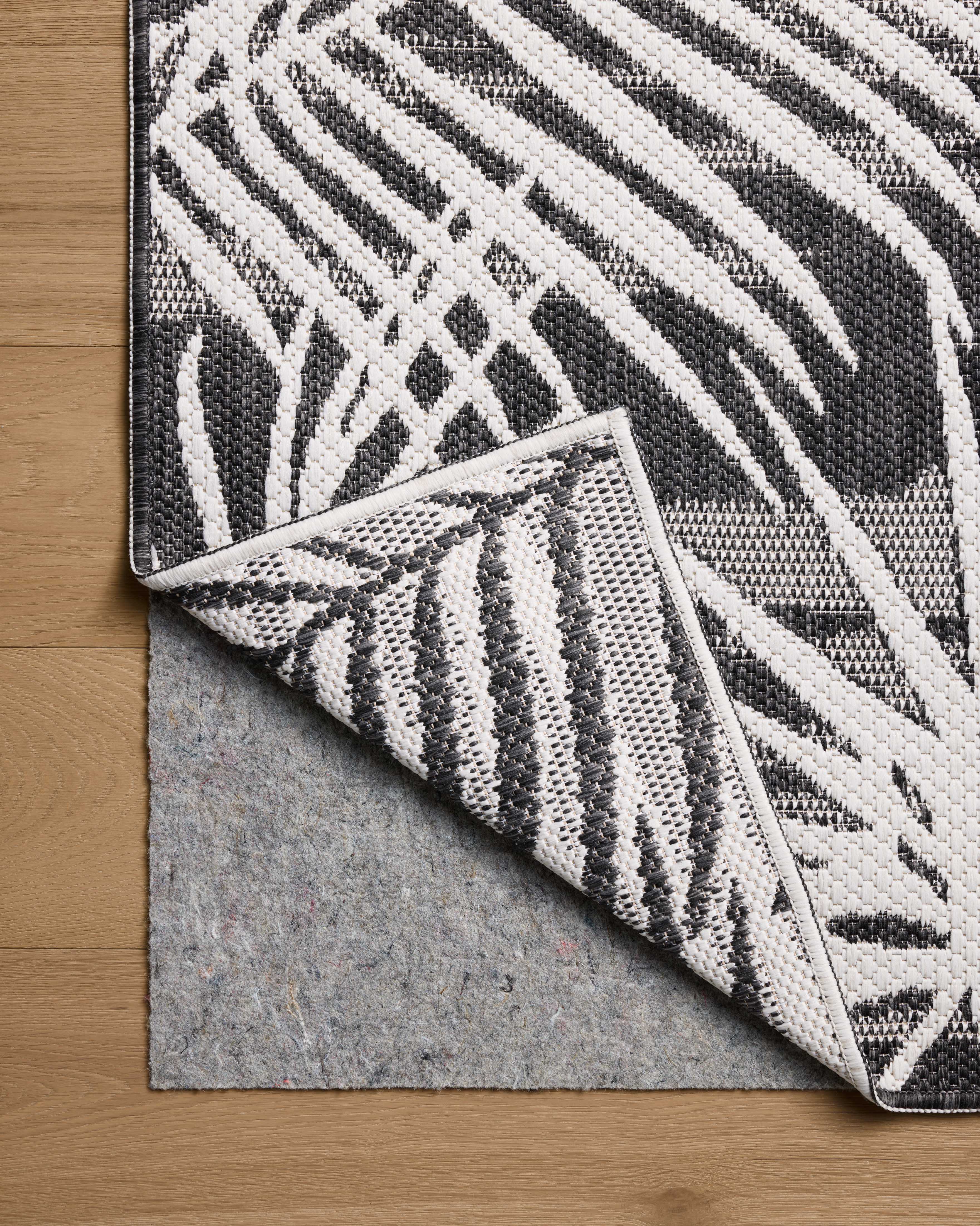 Expertly crafted as a power-loomed polypropylene area rug, the Easton ESN-09 Ivory / Onyx Area Rug captures refined ivory and bold onyx tones beautifully