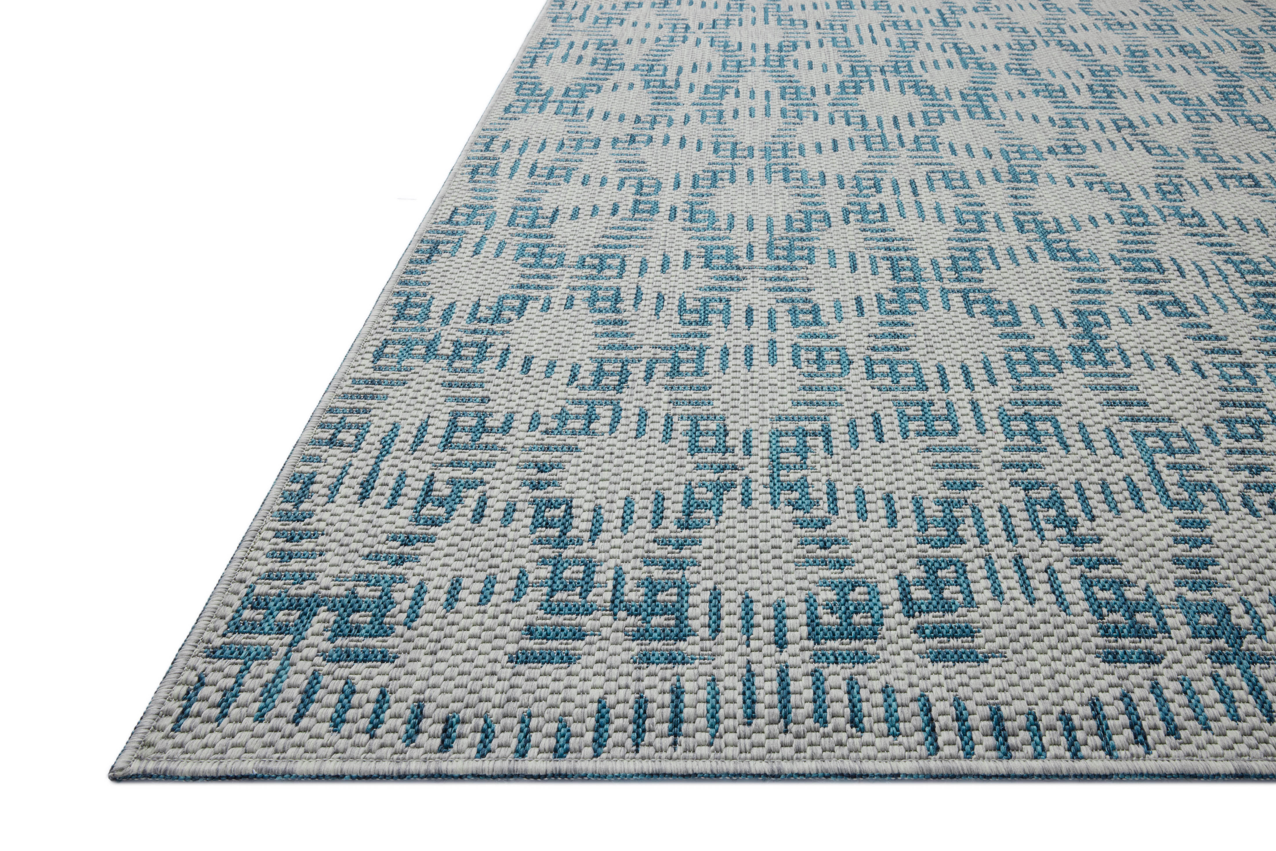 The Easton ESN-10 Fog / Teal Area Rug brings misty and vibrant teal character to your home in a power-loomed polypropylene area rug
