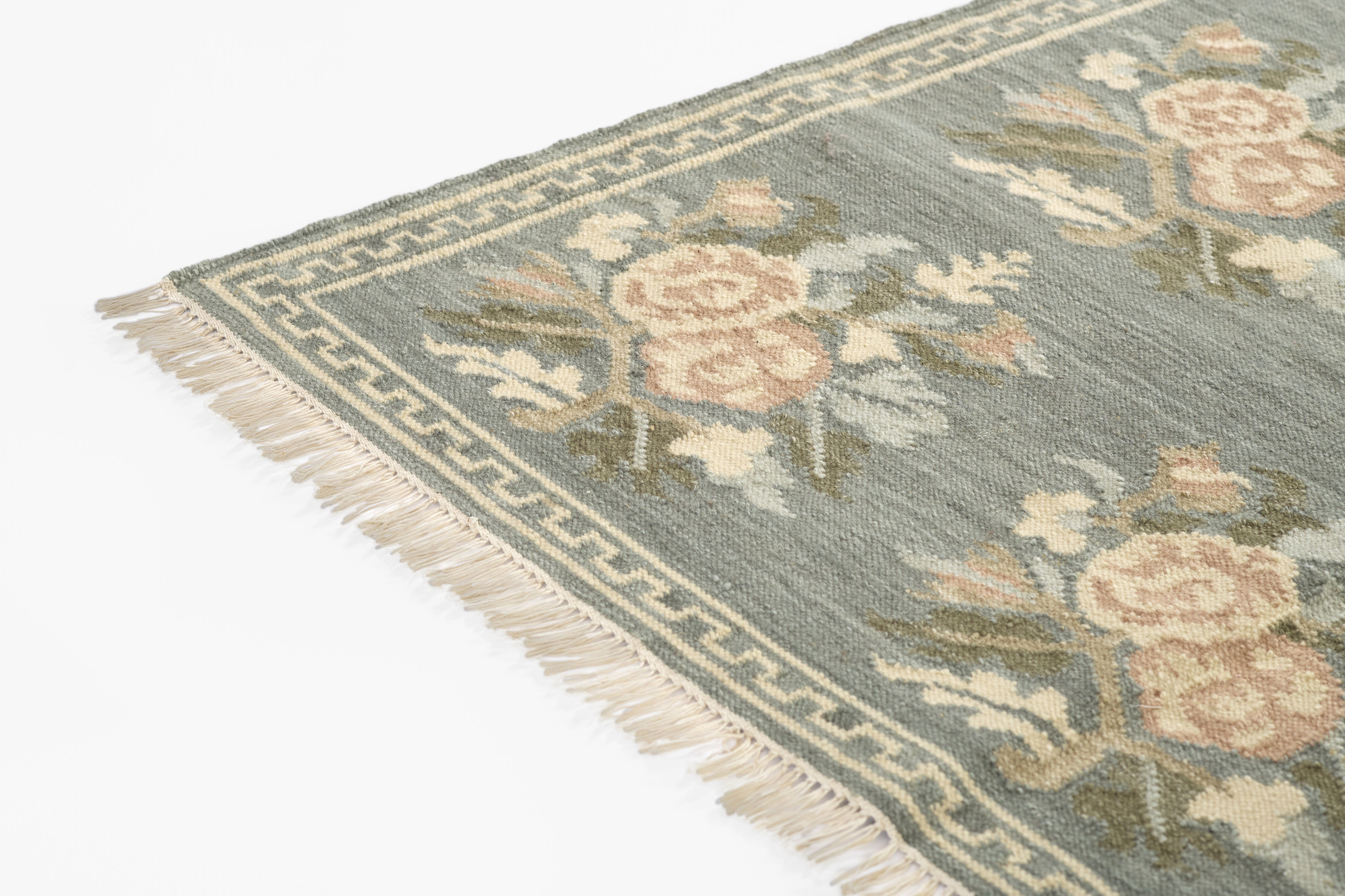 Momeni Florence FLO-1 Blue floral wool area rug with Bessarabian-inspired rose motifs, blush tones, decorative border, and fringed edges.