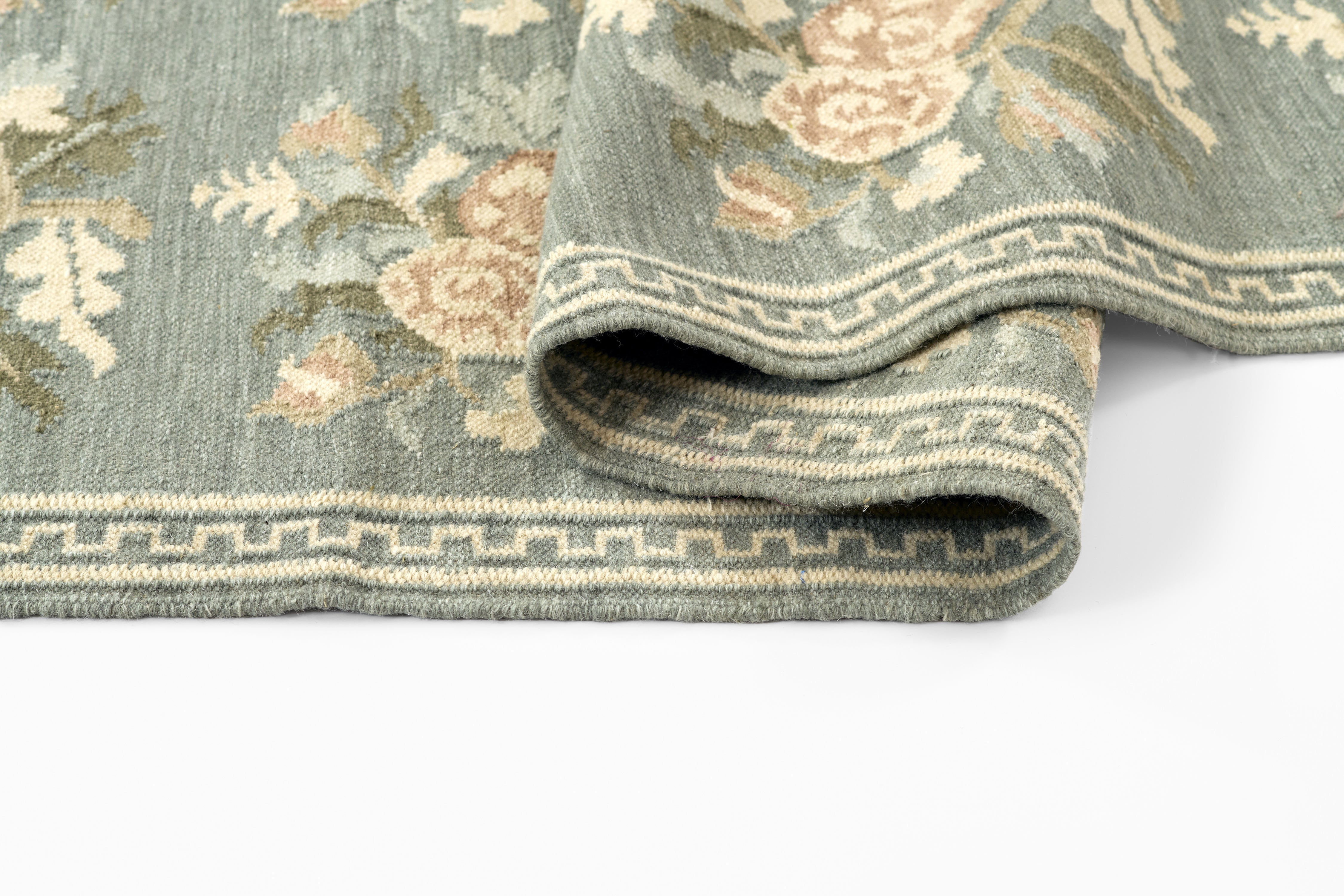 Momeni Florence FLO-1 Blue floral wool area rug with Bessarabian-inspired rose motifs, blush tones, decorative border, and fringed edges.