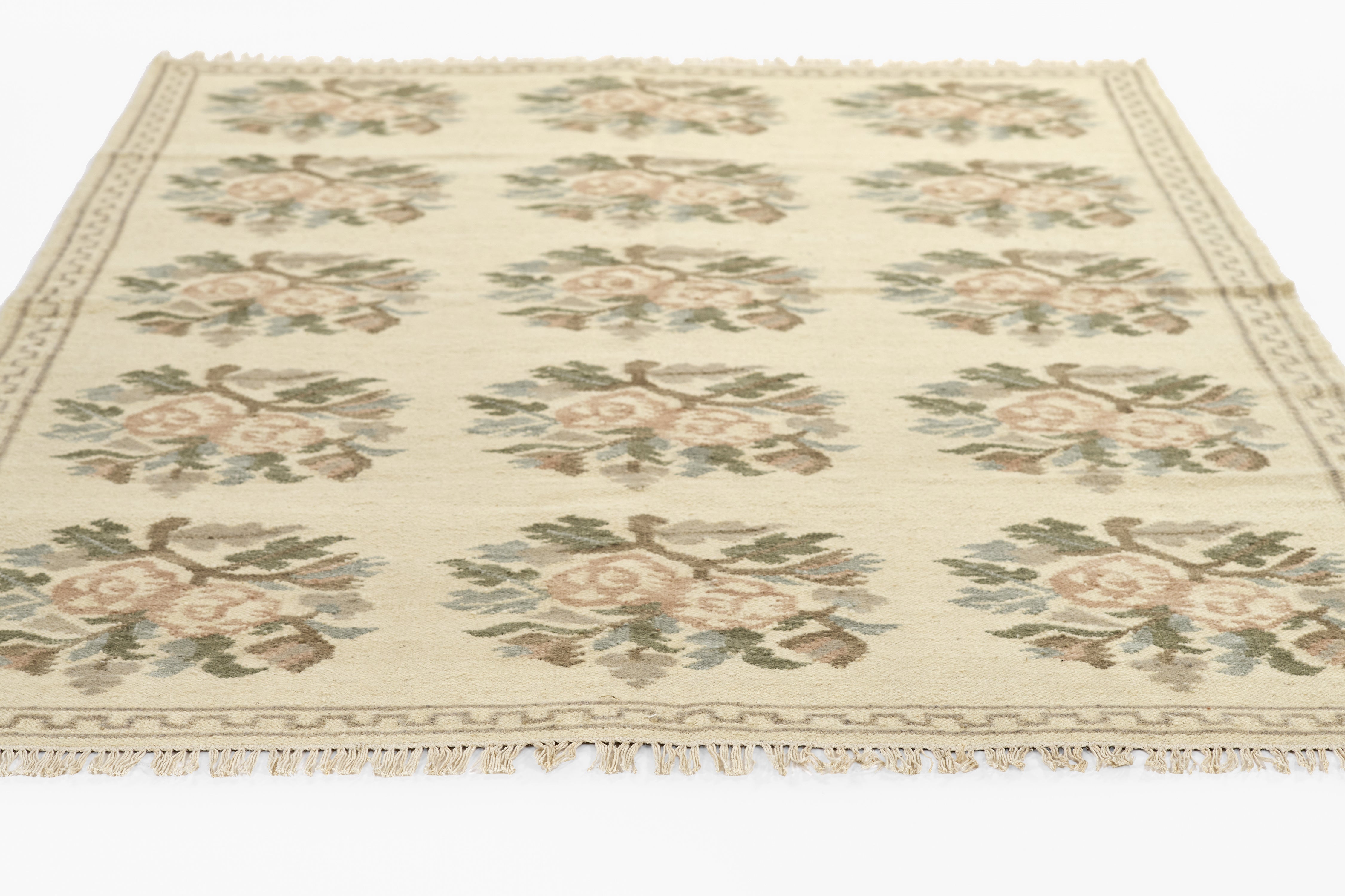 Momeni Florence FLO-1 ivory floral wool area rug with Bessarabian-style rose bouquet design, subtle blue and blush accents, ornamental border, and fringe.