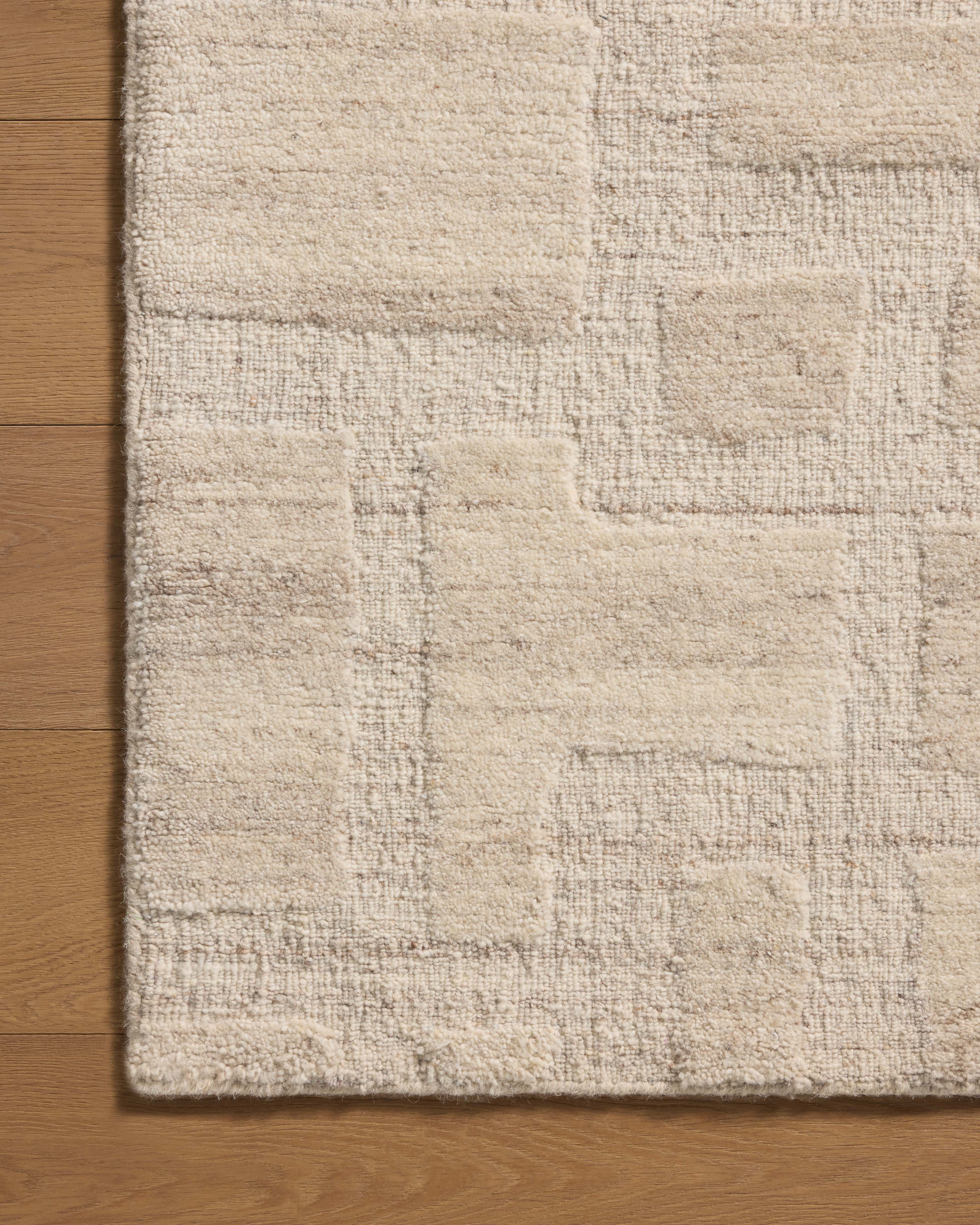 Crafted as a hand-tufted wool area rug, the Hartley HRT-01 Ivory / Natural Area Rug brings refined ivory and warm natural warmth and traditional character to your space