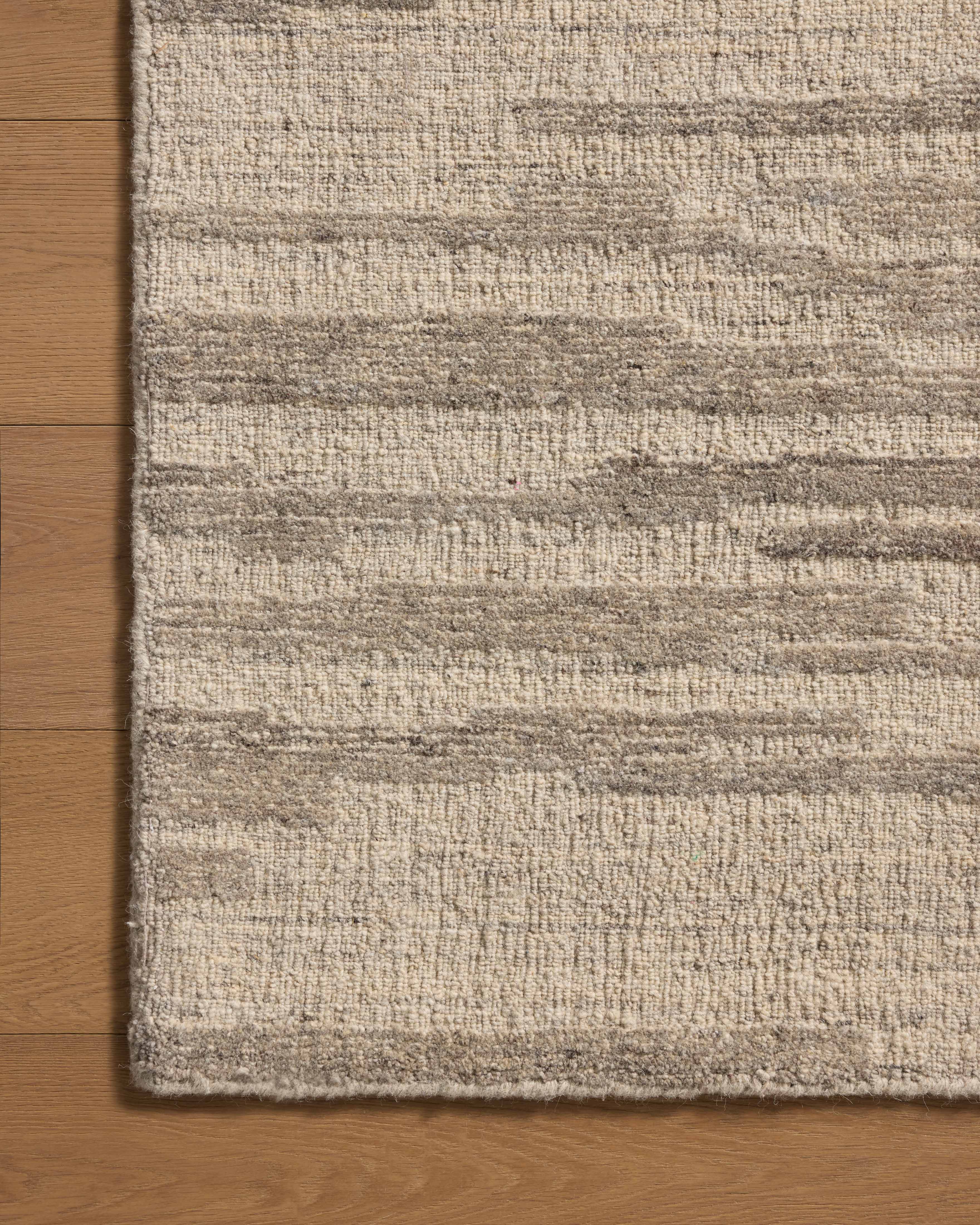 With shimmering silver and elegant grey hues and traditional styling, the Hartley HRT-02 Silver / Grey Area Rug is a hand-tufted wool area rug that elevates any room