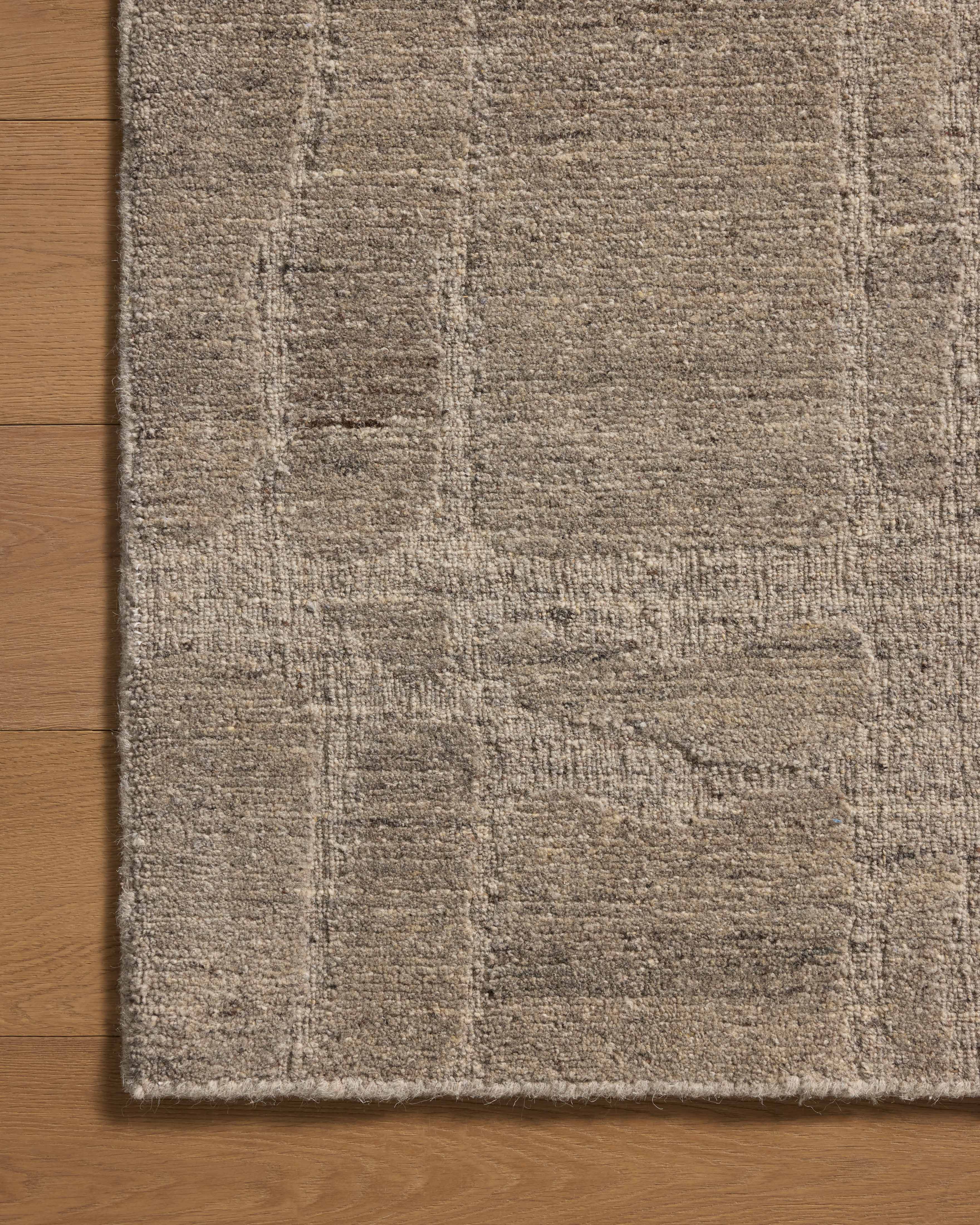 The Hartley HRT-03 Grey / Pebble Area Rug blends elegant grey and subtle pebble tones and traditional motifs into a hand-tufted wool area rug with timeless appeal