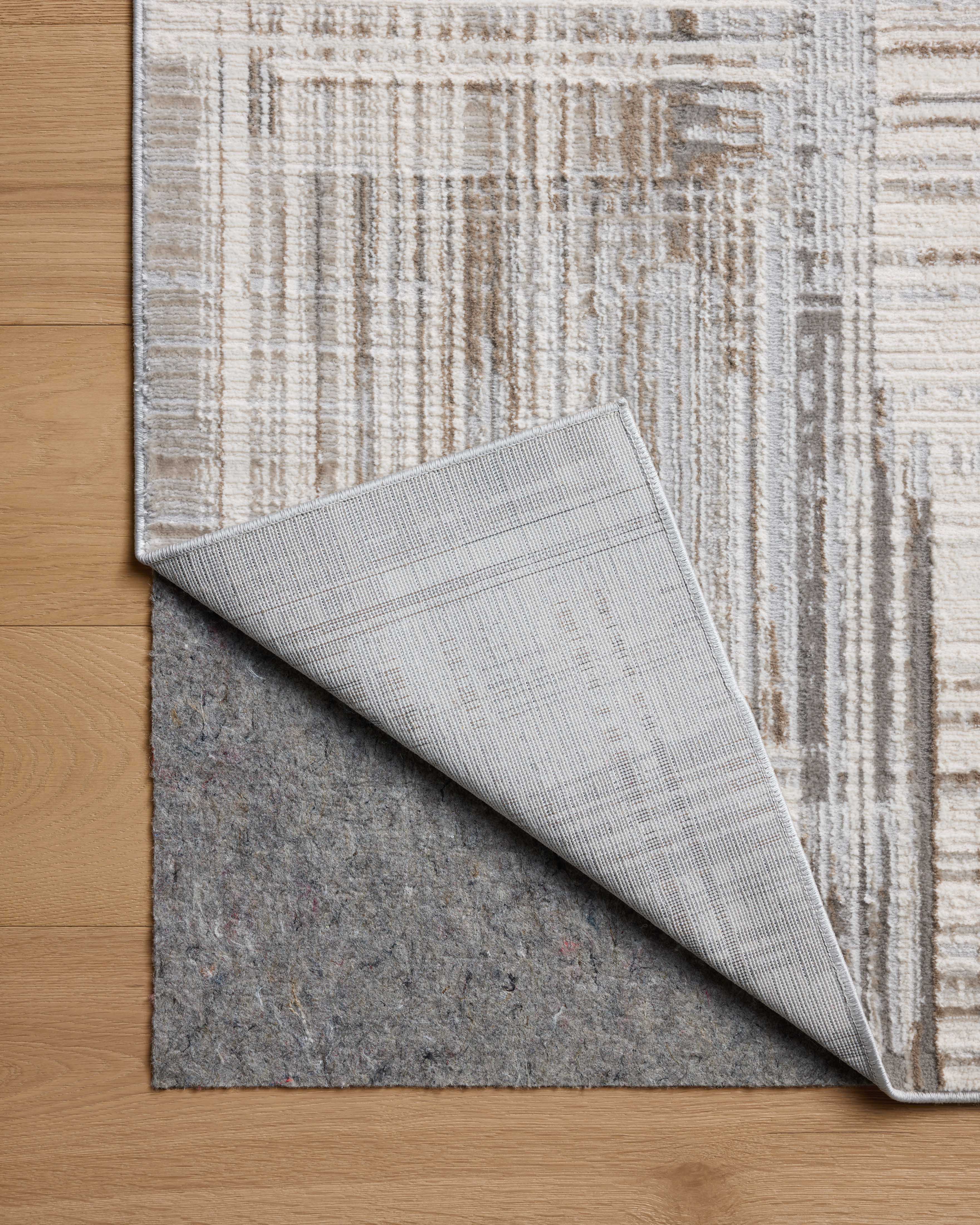 The Hollis HOL-02 Pebble / Ivory Area Rug highlights subtle pebble and refined ivory tones and geometric texture in a beautifully made power-loomed polyester area rug