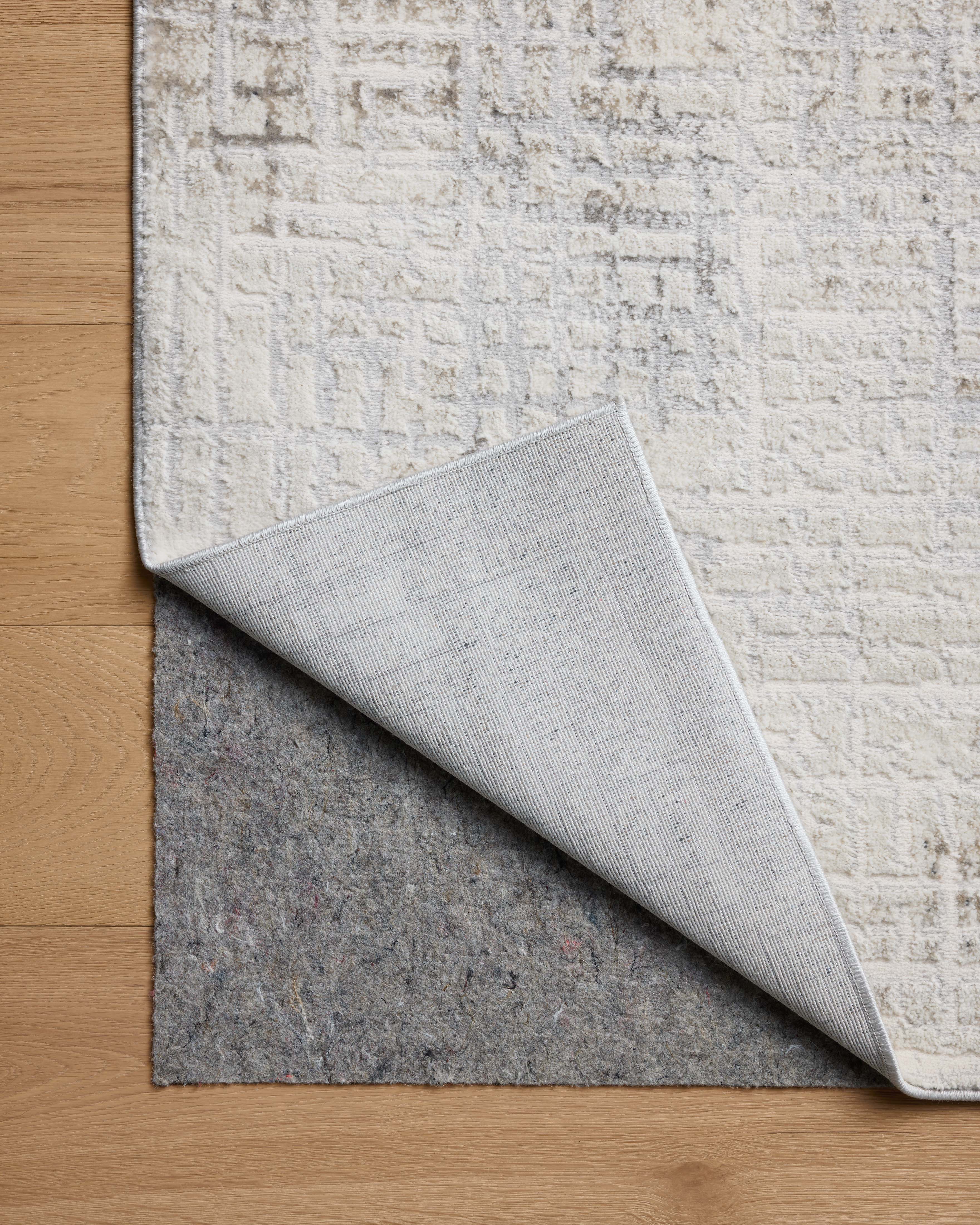 Dressed in refined ivory and grounding stone hues with geometric detail, the Hollis HOL-03 Ivory / Stone Area Rug is a power-loomed polyester area rug that completes any room