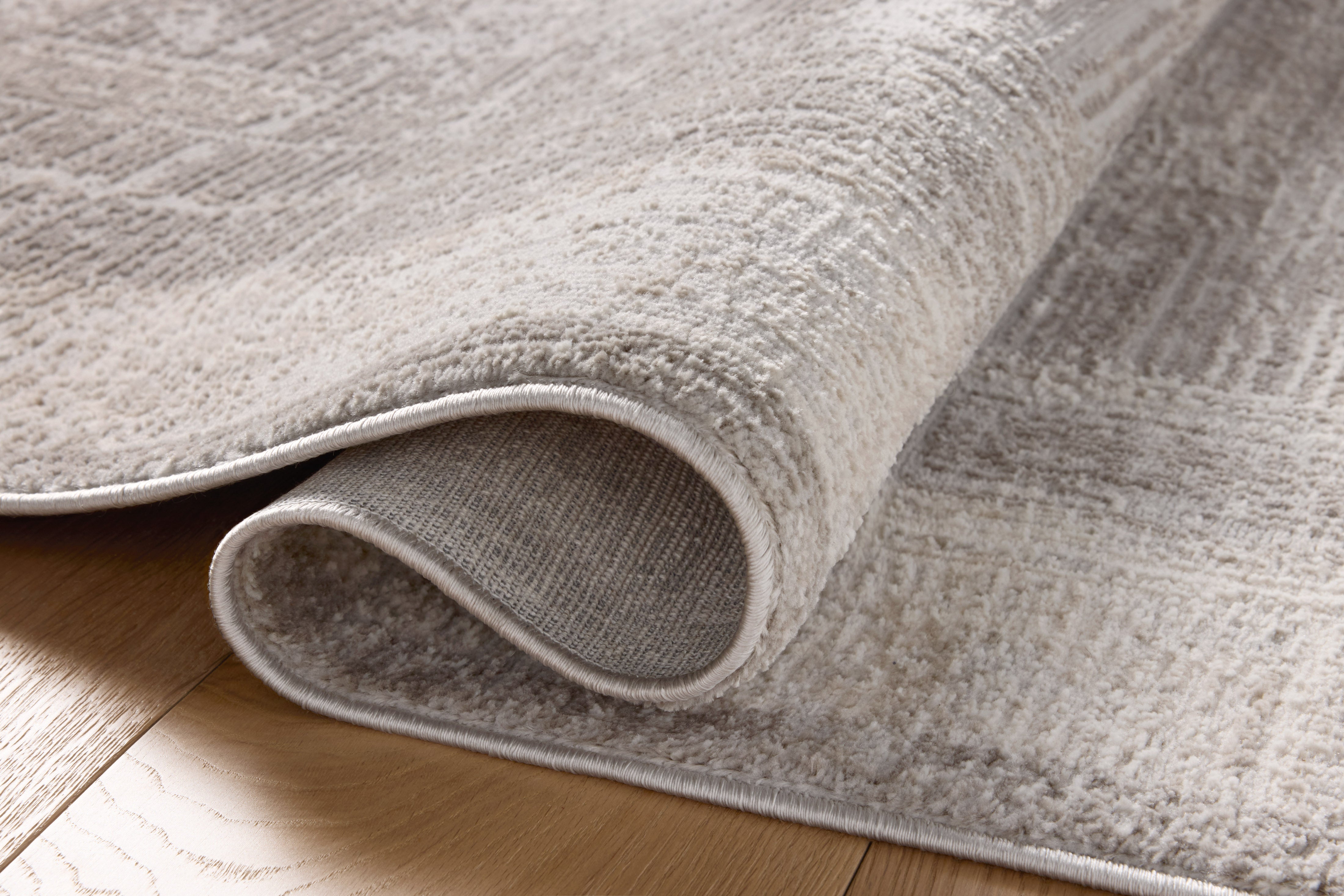 The Hollis HOL-04 Smoke / Mist Area Rug transforms any space with smoky and soft misty tones and geometric design in a power-loomed polyester area rug