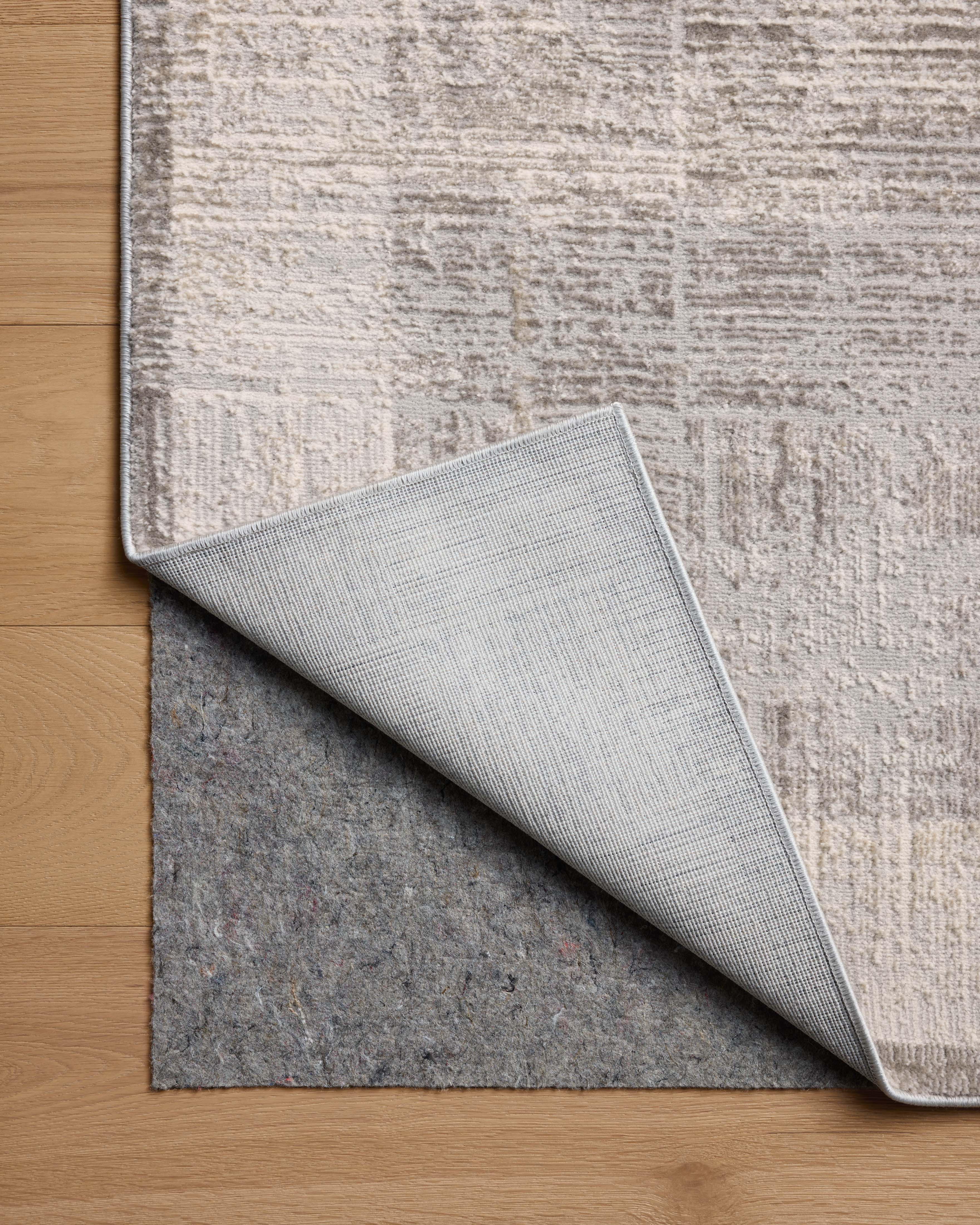 The Hollis HOL-04 Smoke / Mist Area Rug transforms any space with smoky and soft misty tones and geometric design in a power-loomed polyester area rug