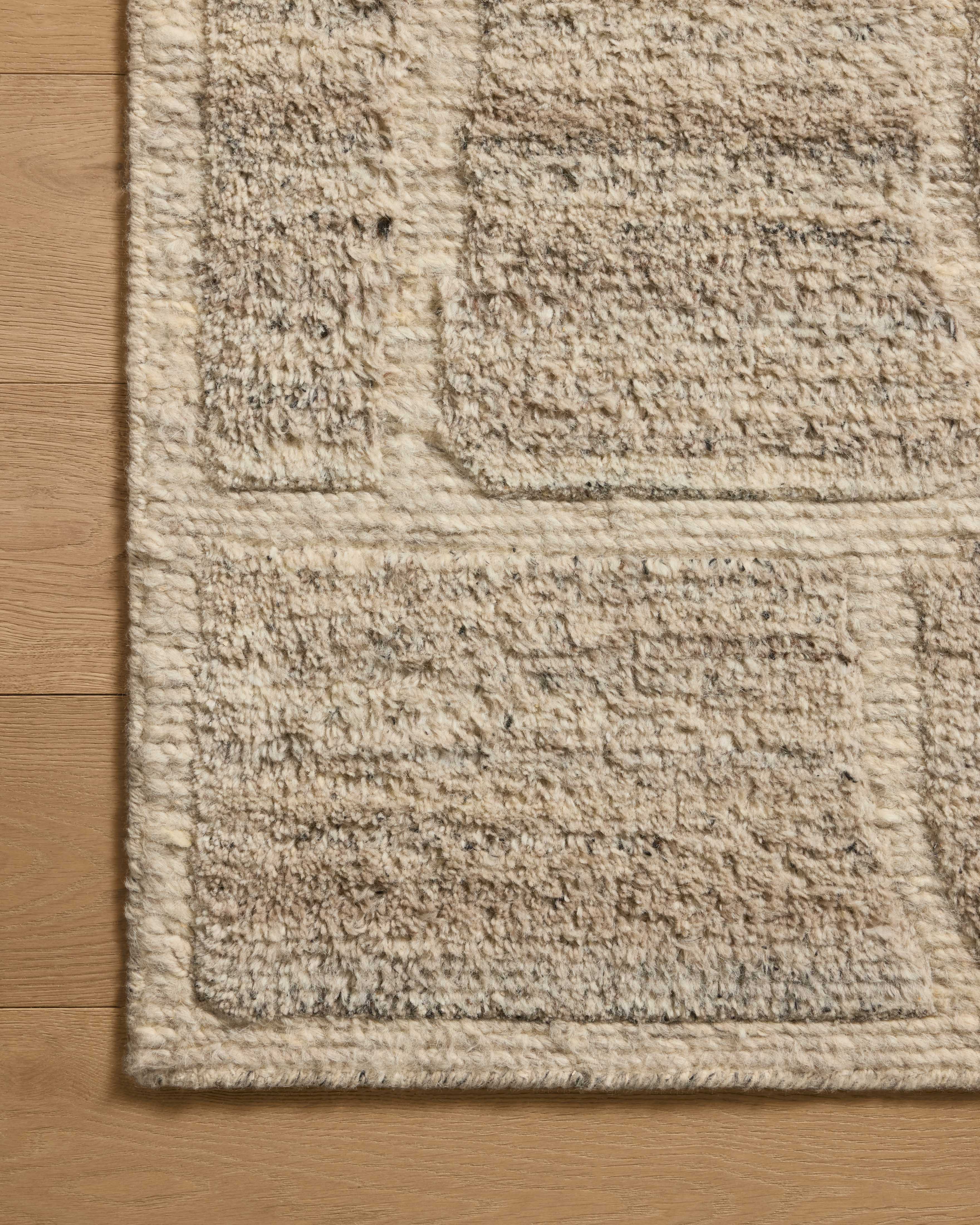 Dressed in gentle dove hues with graphic detail, the Hughes HUS-01 Dove Area Rug is a hand-knotted wool area rug that completes any room