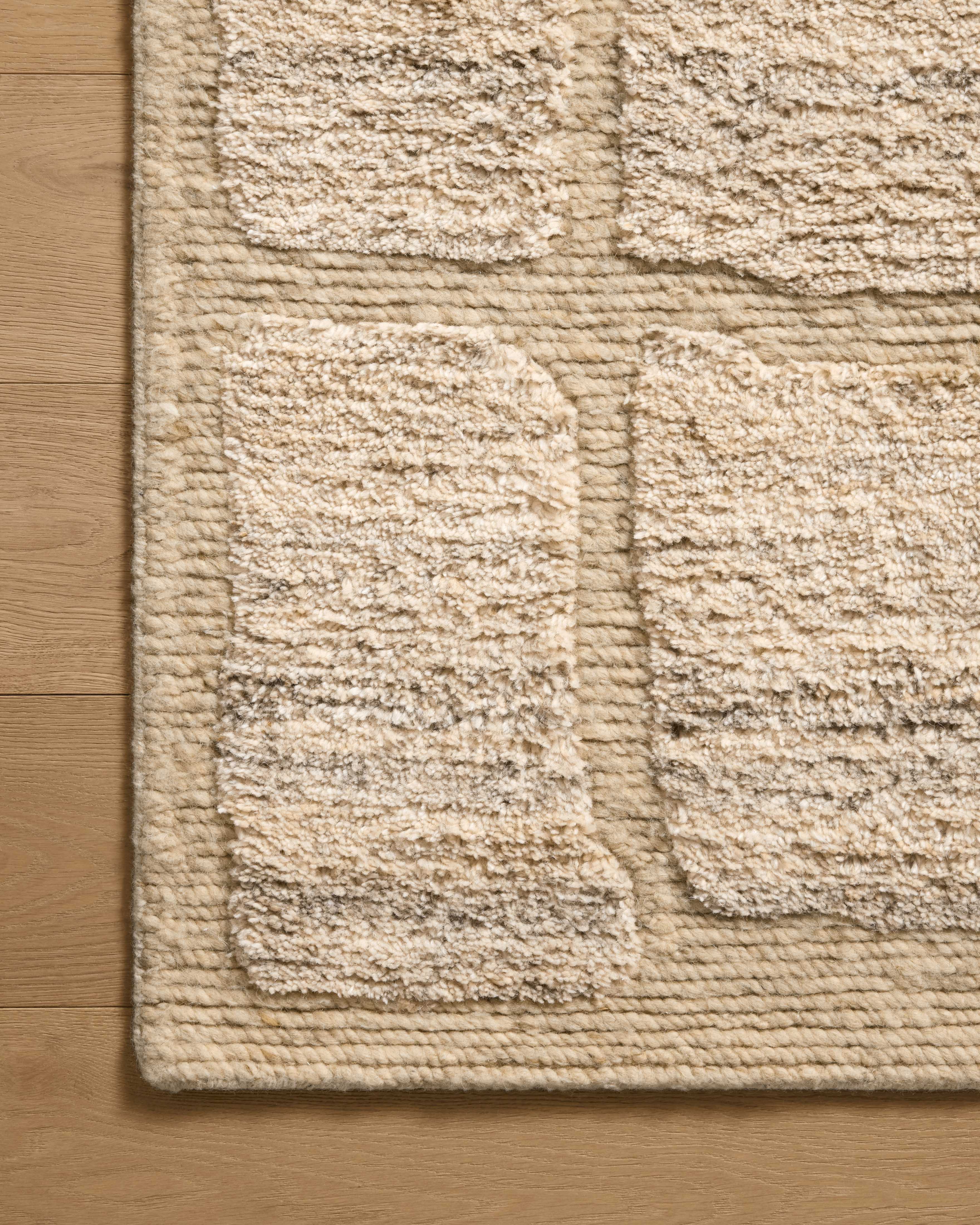 The Hughes HUS-01 Natural Area Rug transforms any space with warm natural tones and graphic design in a hand-knotted wool area rug