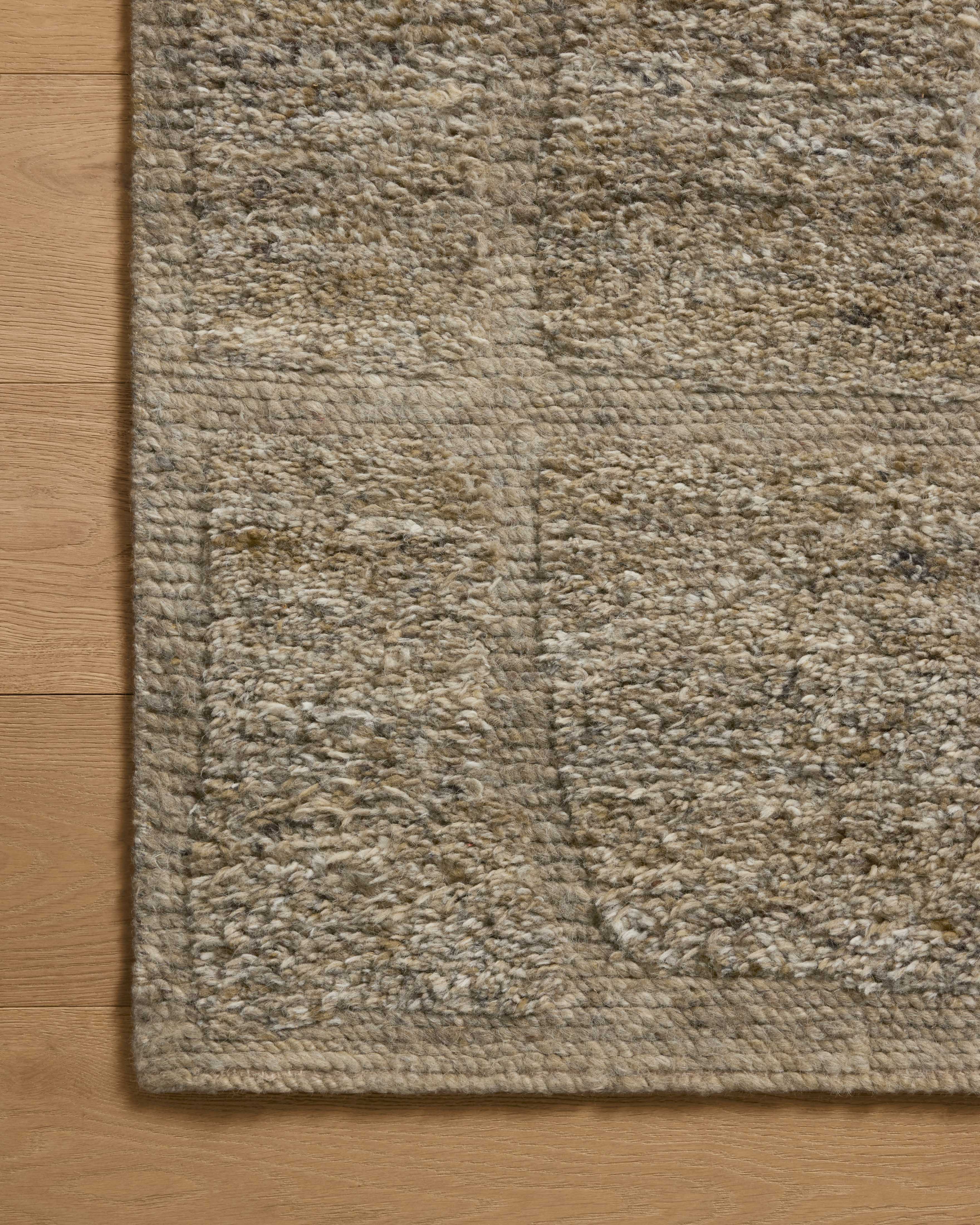 A hand-knotted wool area rug in earthy olive tones with graphic motifs, the Hughes HUS-01 Olive Area Rug grounds your room beautifully