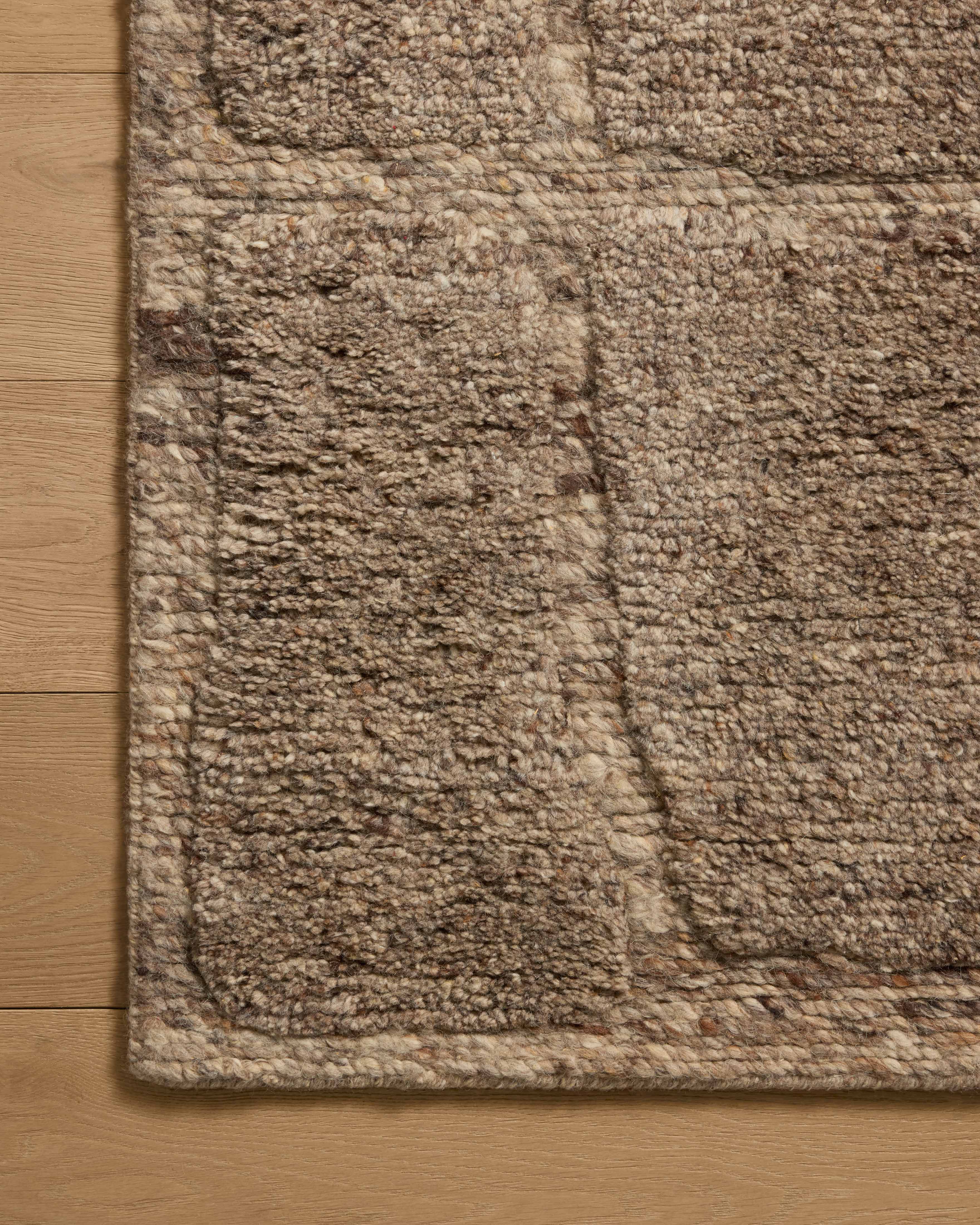 Layered in versatile taupe hues with graphic patterns, the Hughes HUS-01 Taupe Area Rug is a hand-knotted wool area rug perfect for any setting