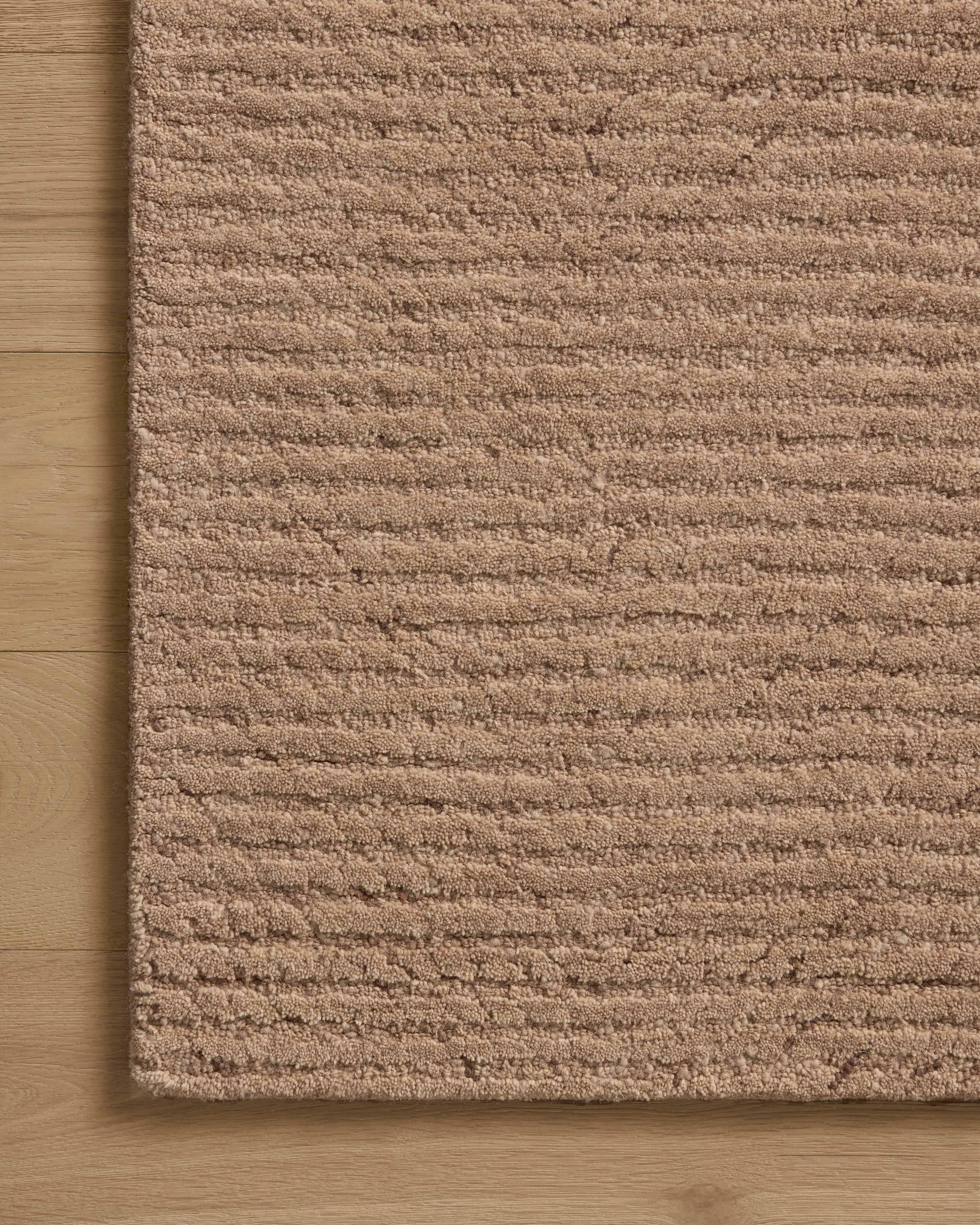 Finished in delicate blush tones with ribbed styling, the Kai KAI-01 Blush Area Rug is a hand-tufted wool area rug for modern living