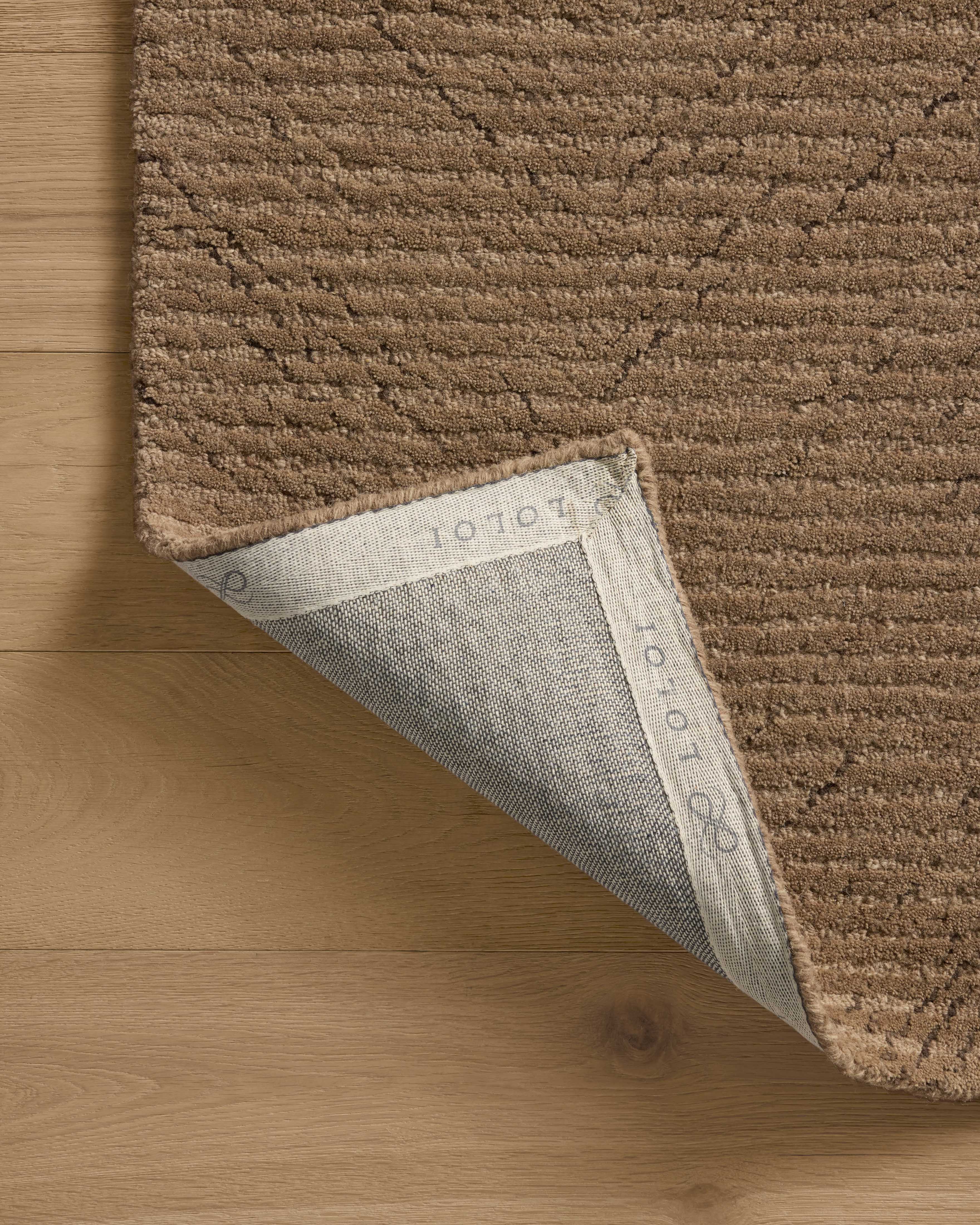 The Kai KAI-01 Pebble Area Rug highlights subtle pebble tones and ribbed texture in a beautifully made hand-tufted wool area rug