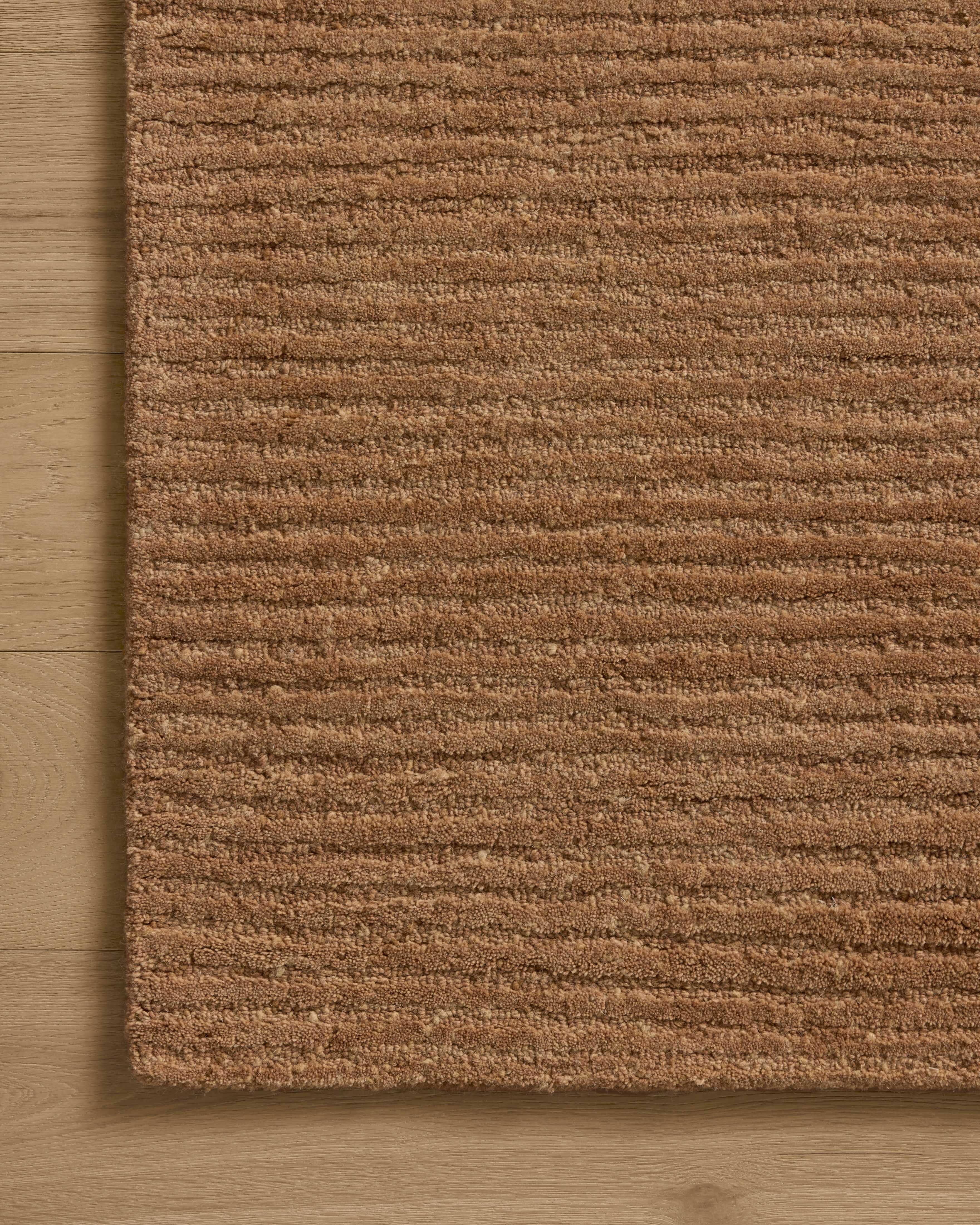 Dressed in rich terracotta hues with ribbed detail, the Kai KAI-01 Terracotta Area Rug is a hand-tufted wool area rug that completes any room