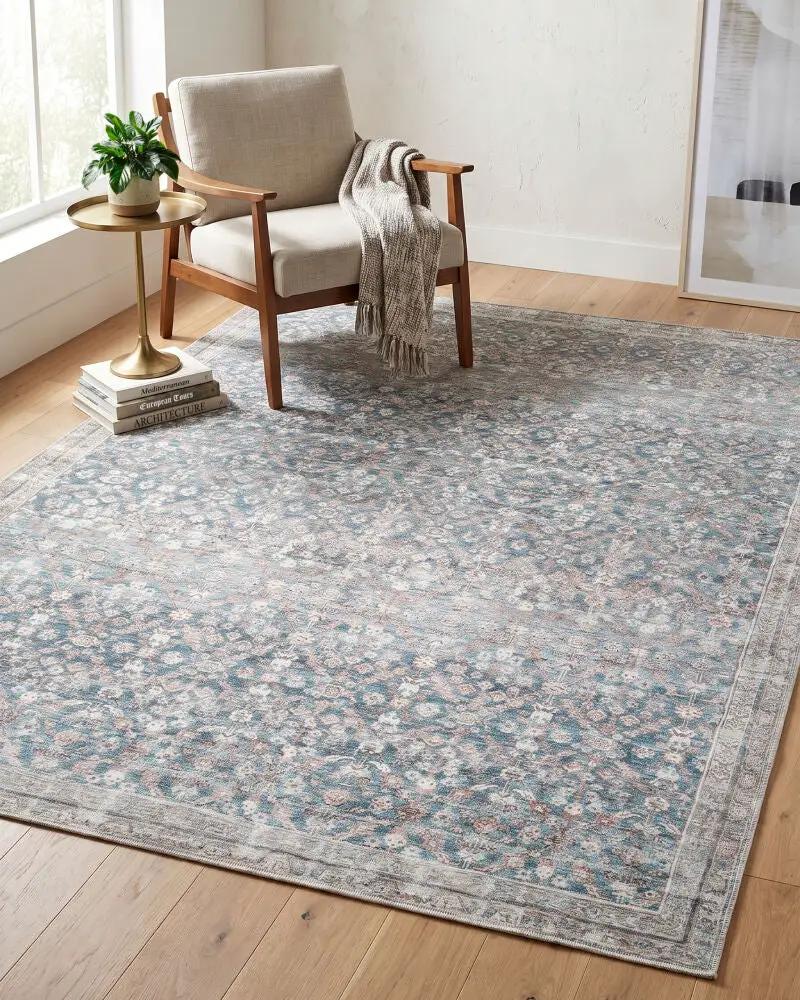 Amelia JYAL-2303 Sky Blue Area Rug with a floral pattern in a living room with a chair and table.