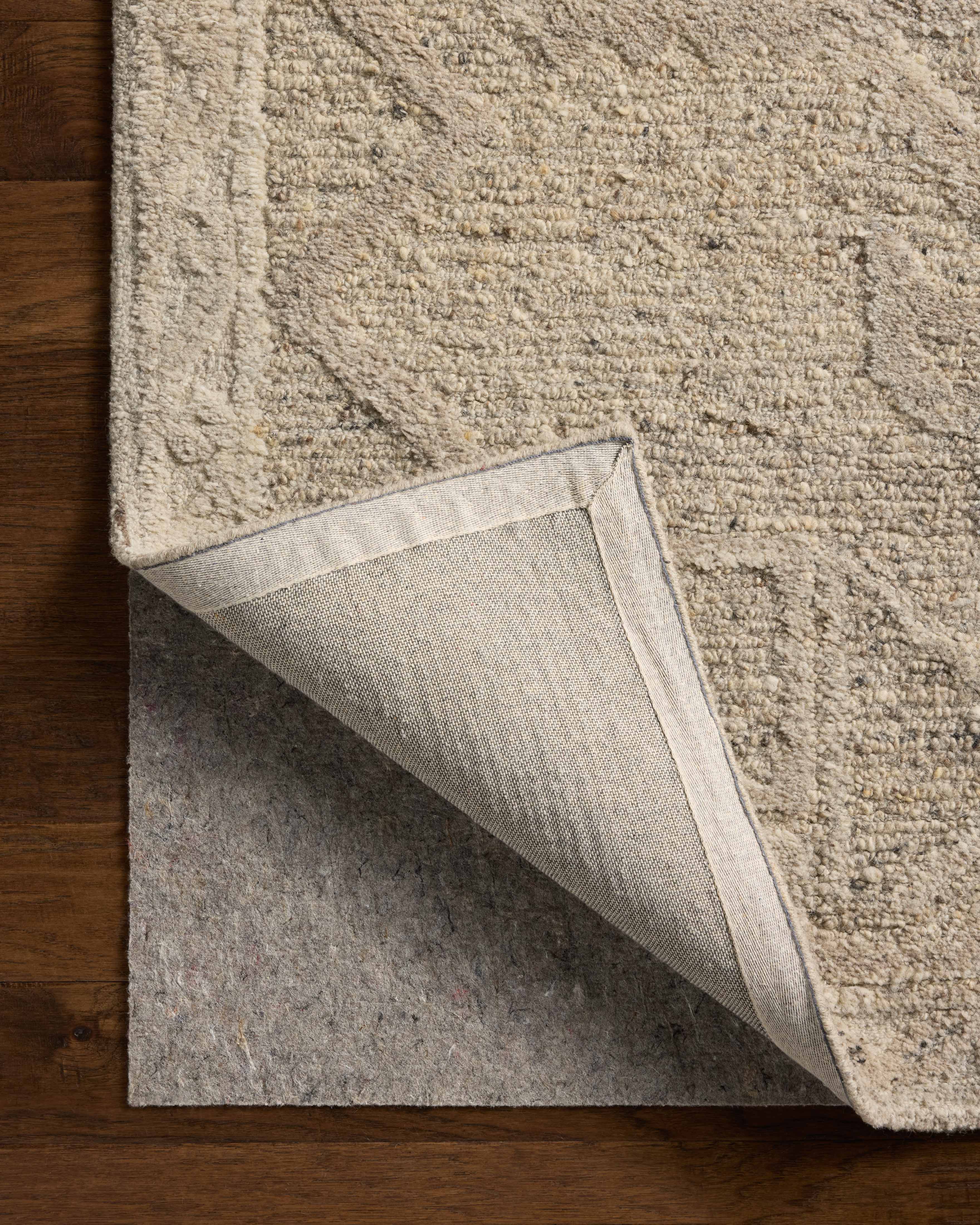 Rich in subtle pebble and soft misty hues with traditional detail, the Mabel MBL-01 Pebble / Mist Area Rug is a hand-tufted wool area rug built for style and comfort